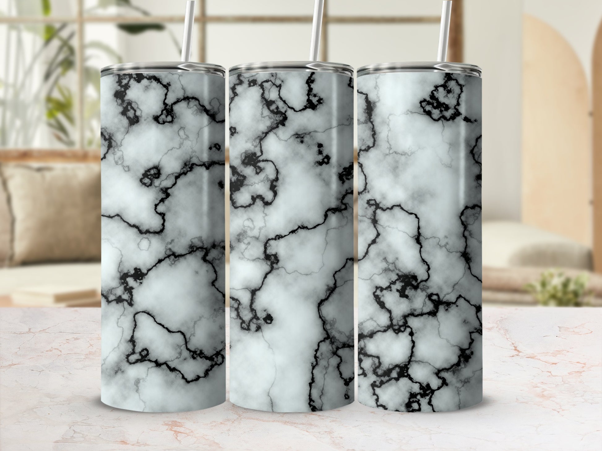 Three tumblers with a white and black marble pattern.