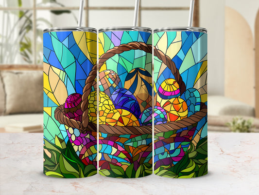 Stained glass tumbler with Easter eggs in a basket on a marble countertop.