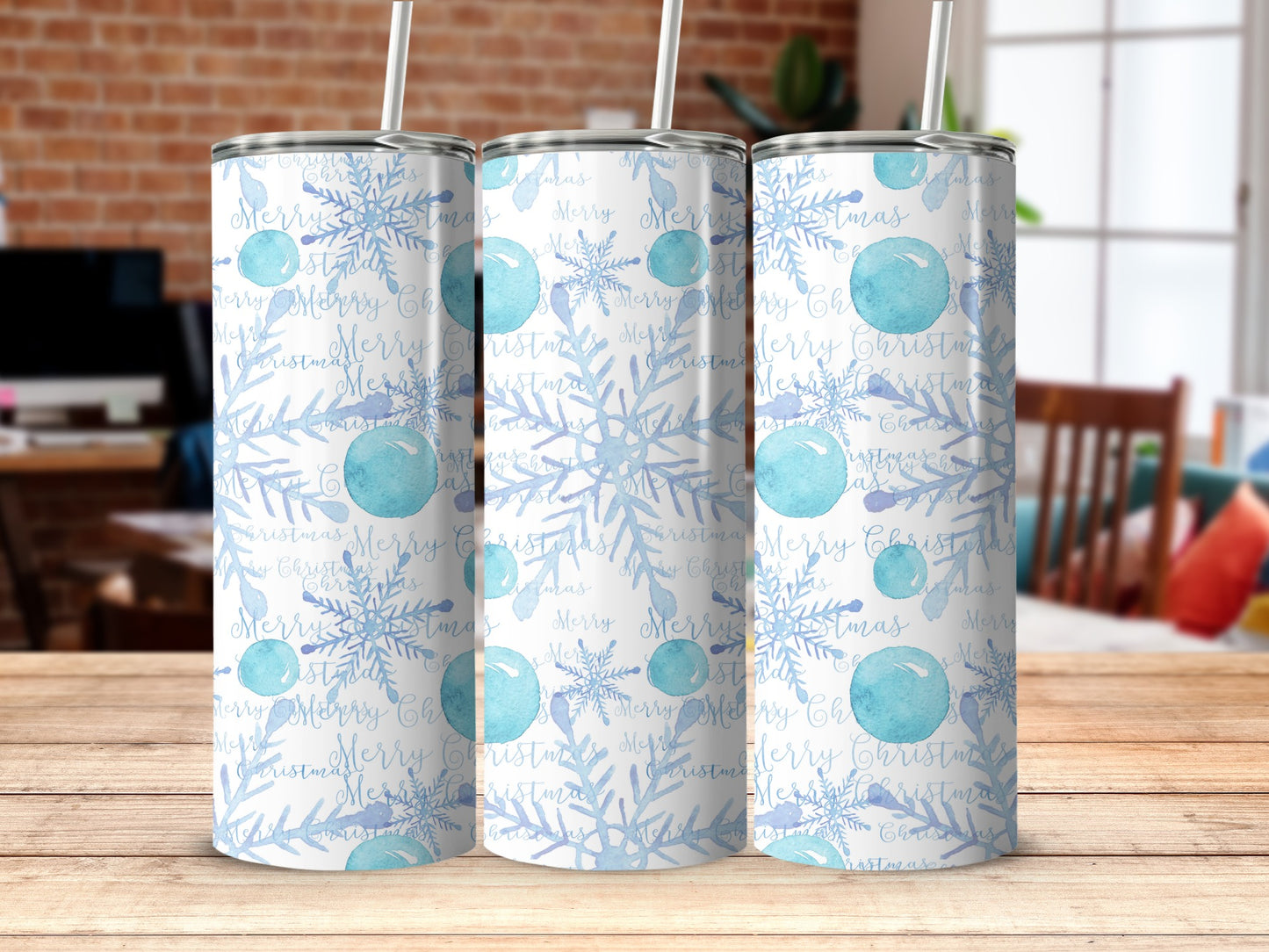Tumblers with blue snowflakes and "Merry Christmas" text on a wooden surface.