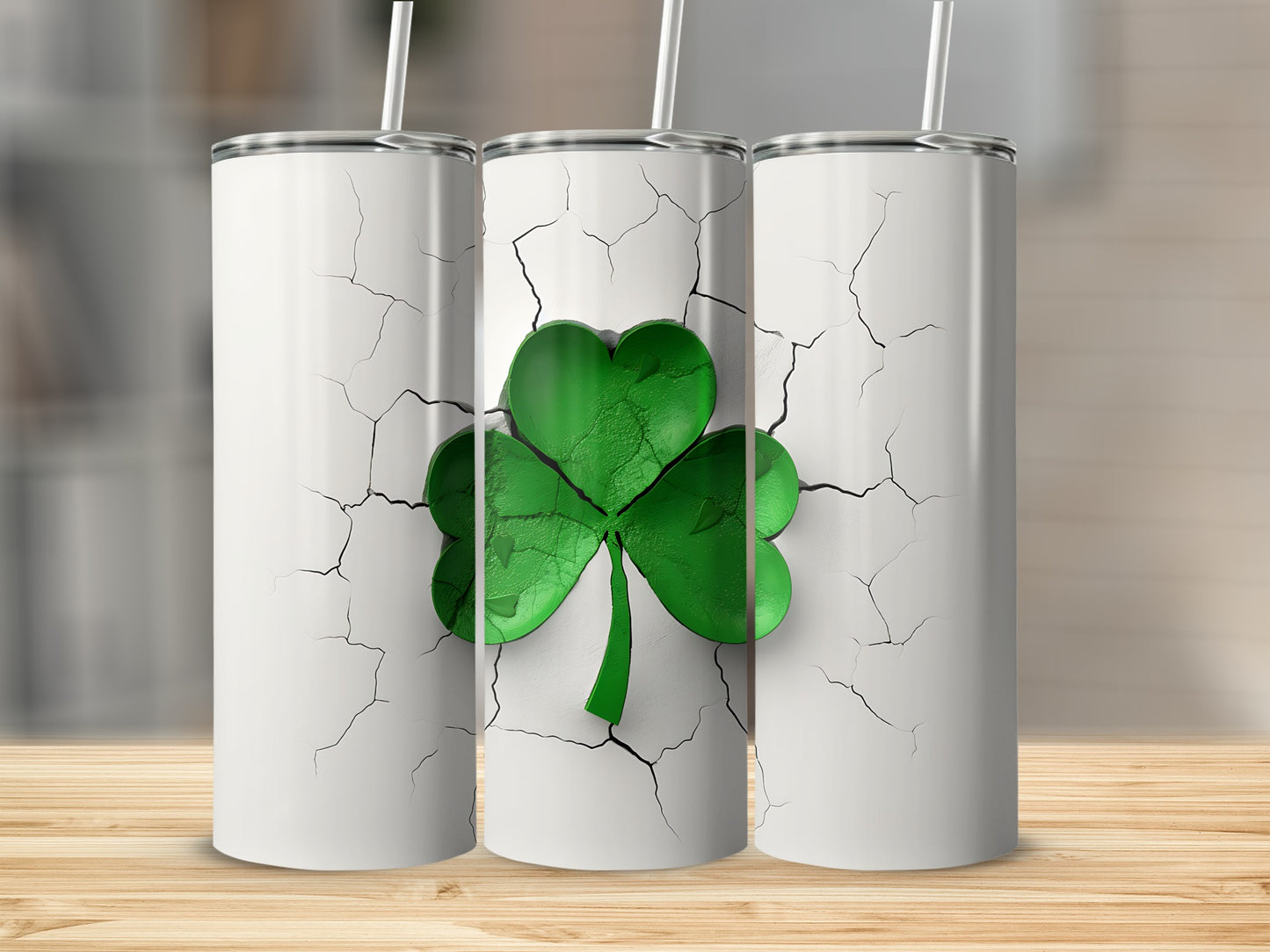 Three white tumblers with cracked surface and green shamrock design.