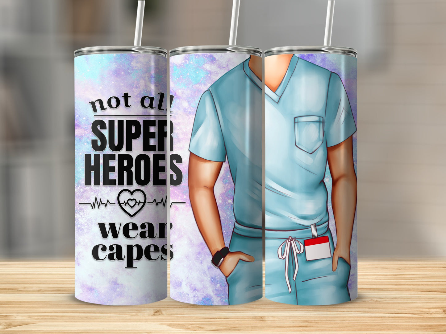 Blue scrub top tumbler with "Not all heroes wear capes" text and heart graphic.