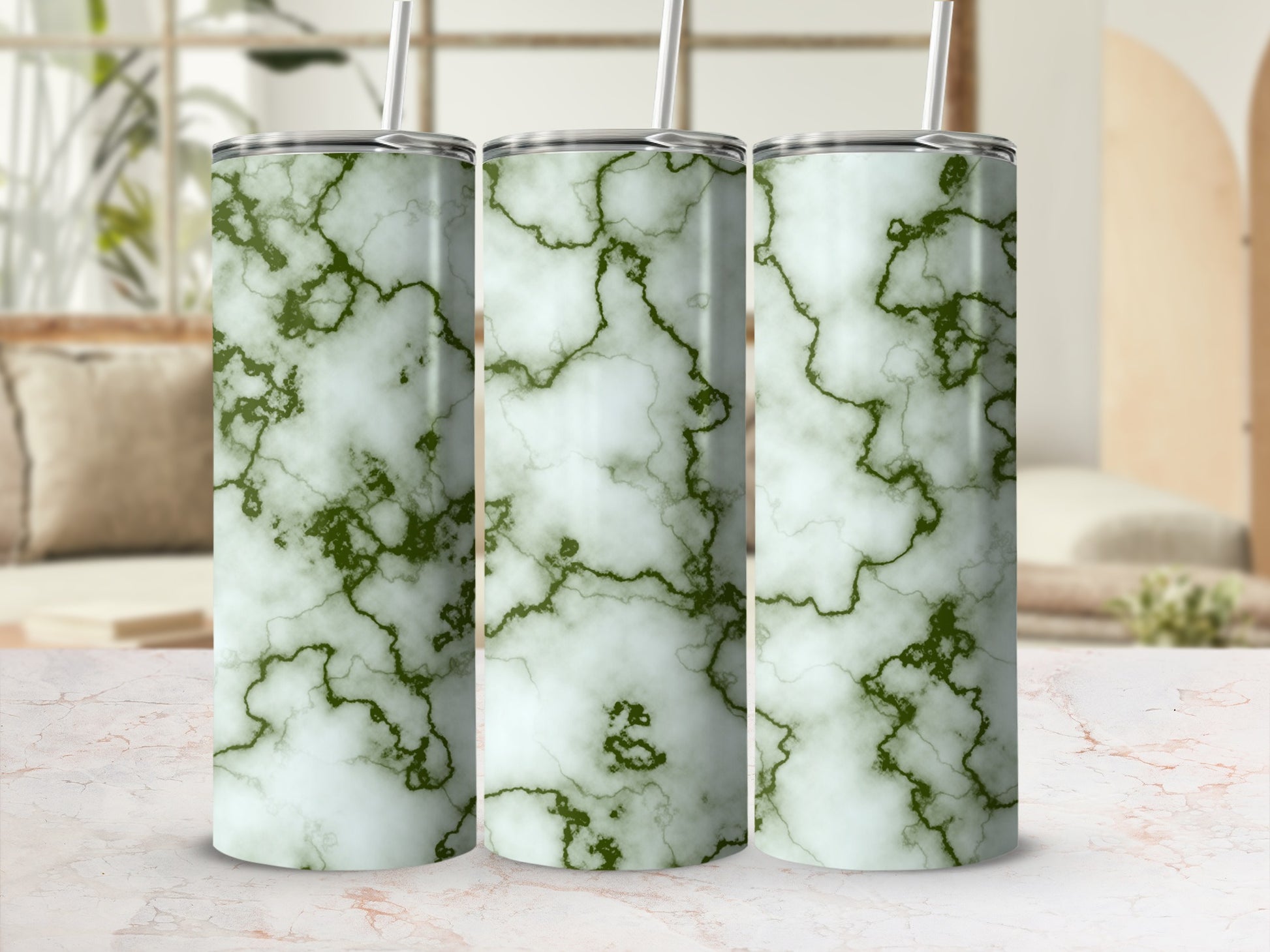 Three tumblers with a green marble pattern stand on a surface.