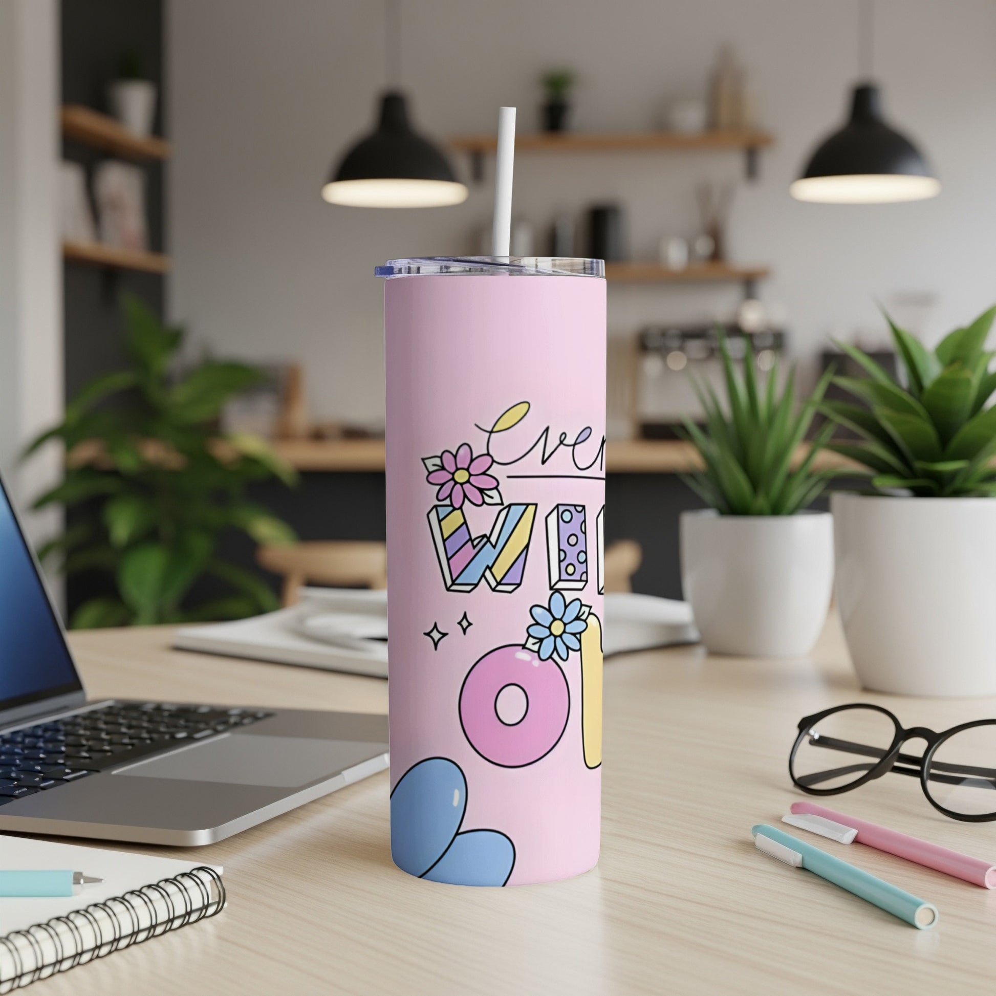 Pink tumbler with "Everyone is welcome" text and floral designs.
