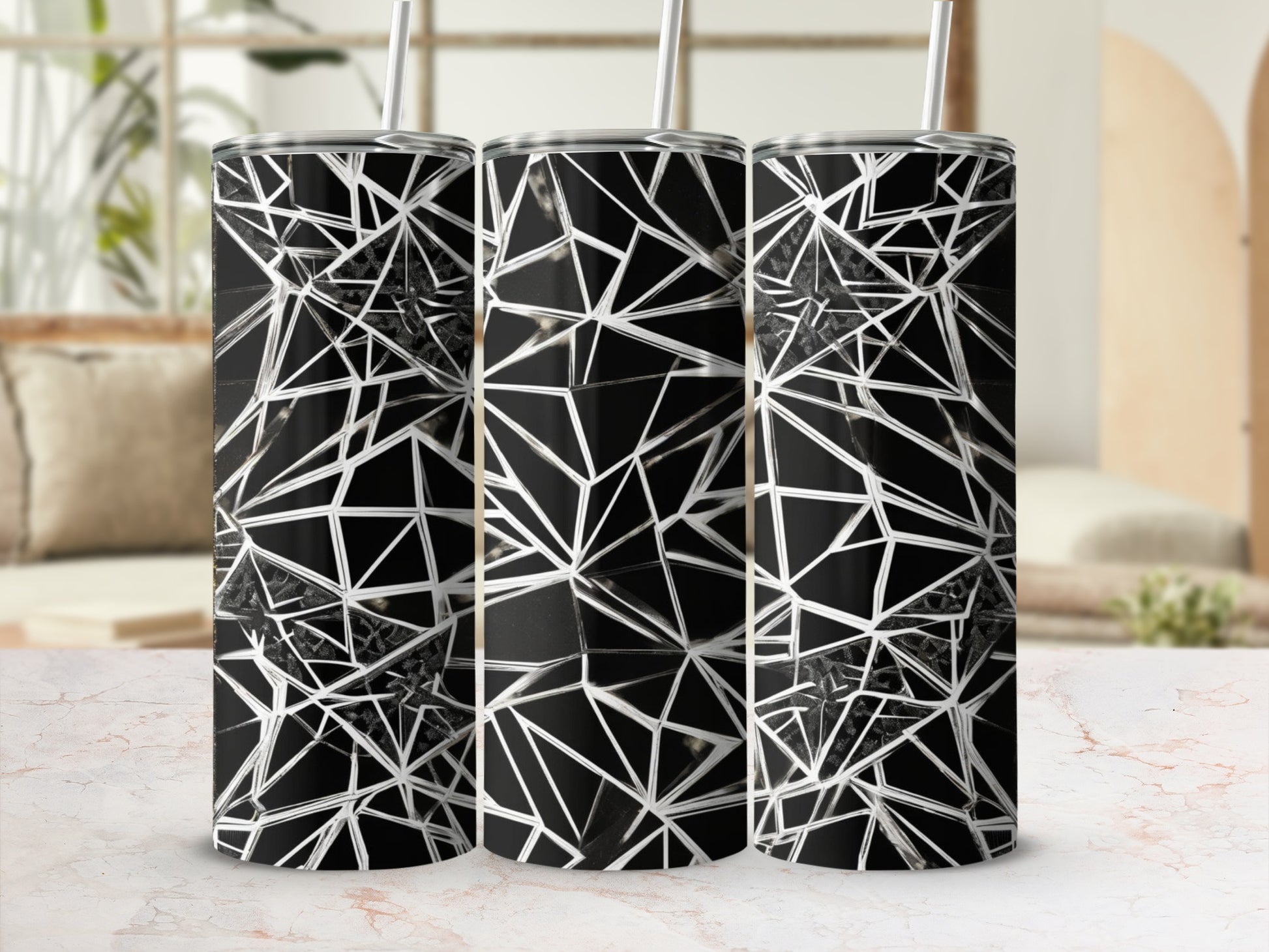 Black and white geometric shattered glass pattern on three tumblers.