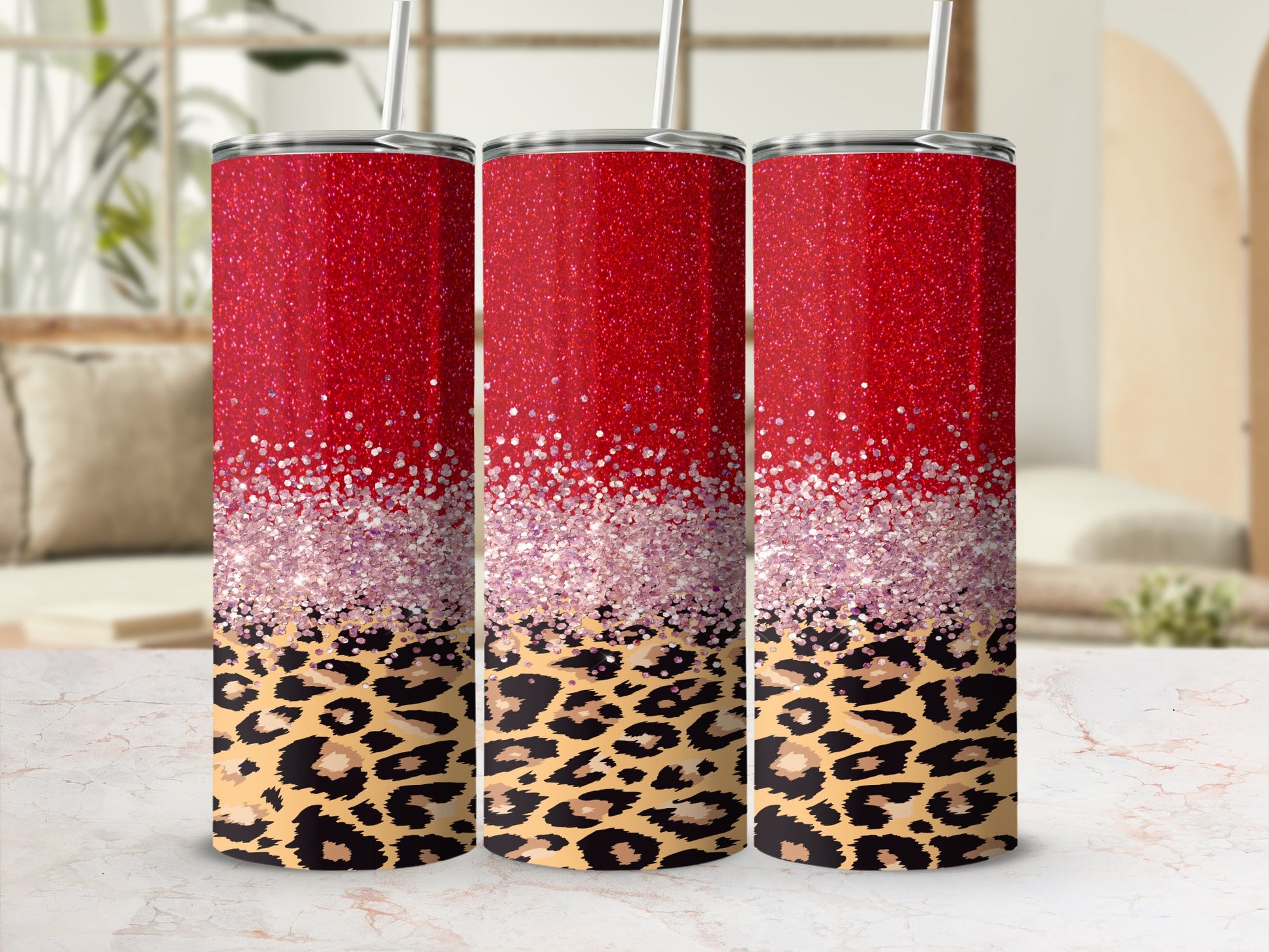 Three glitter-covered tumblers with leopard print bases.