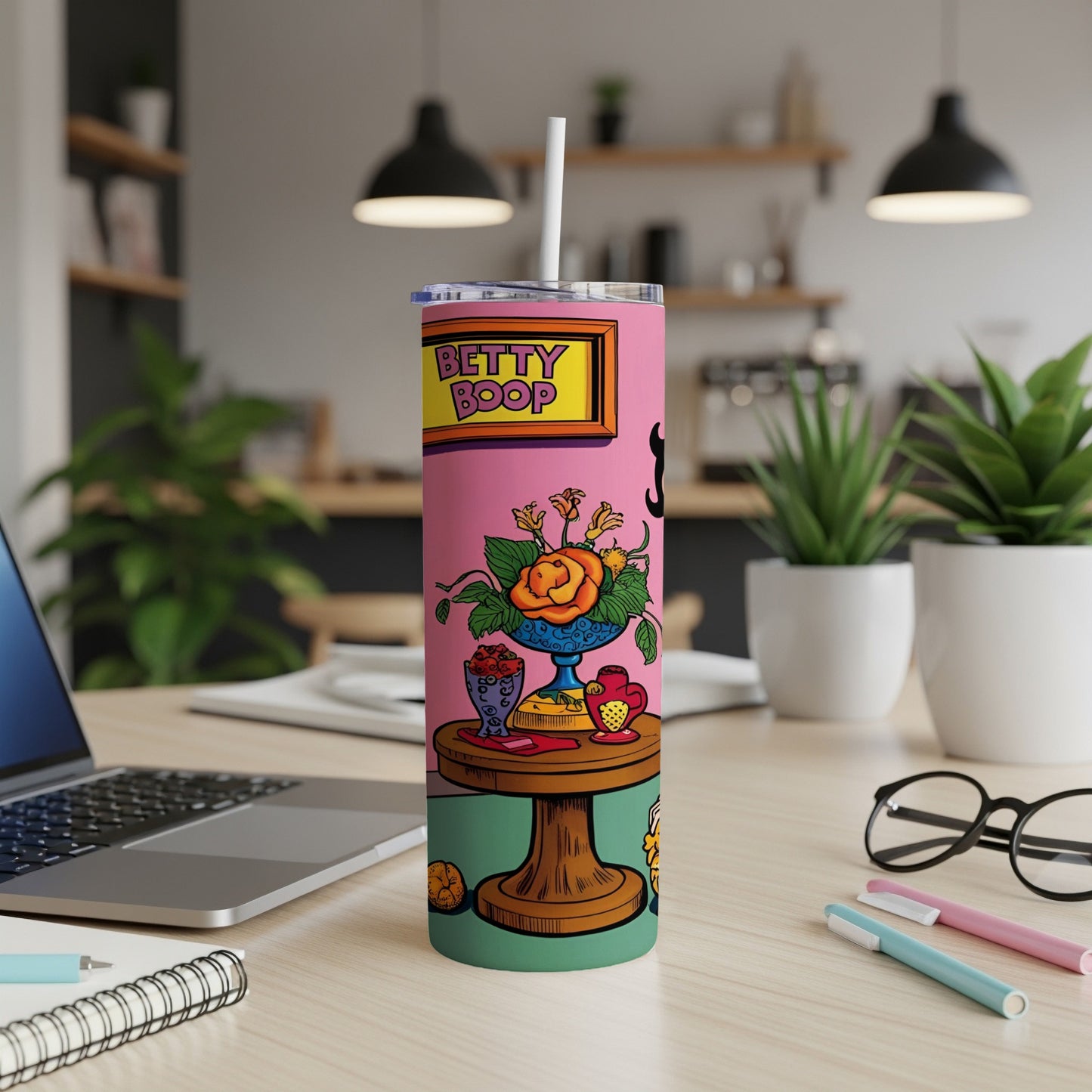 Betty Boop tumbler with cartoon illustration on a desk.