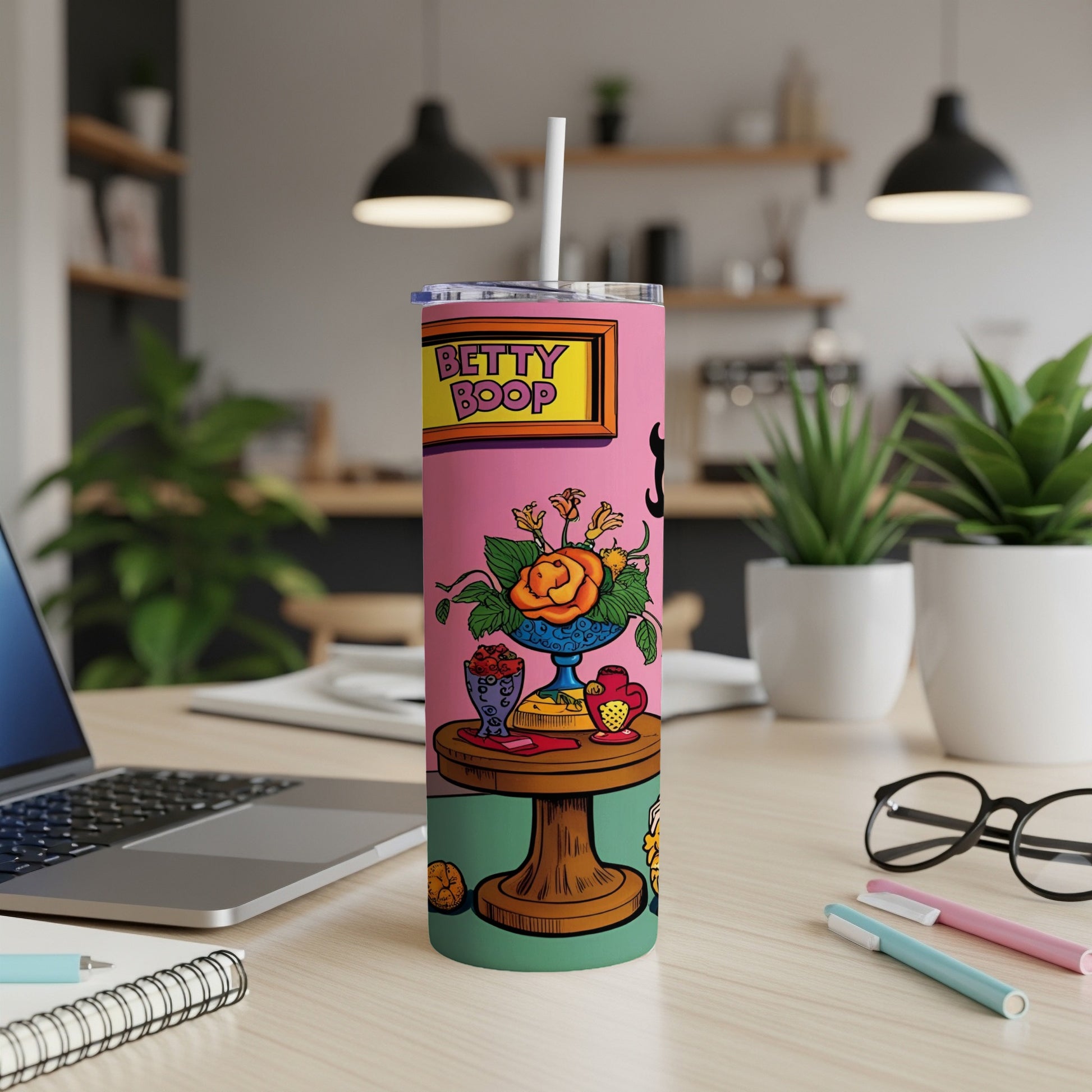 Betty Boop tumbler with cartoon illustration on a desk.