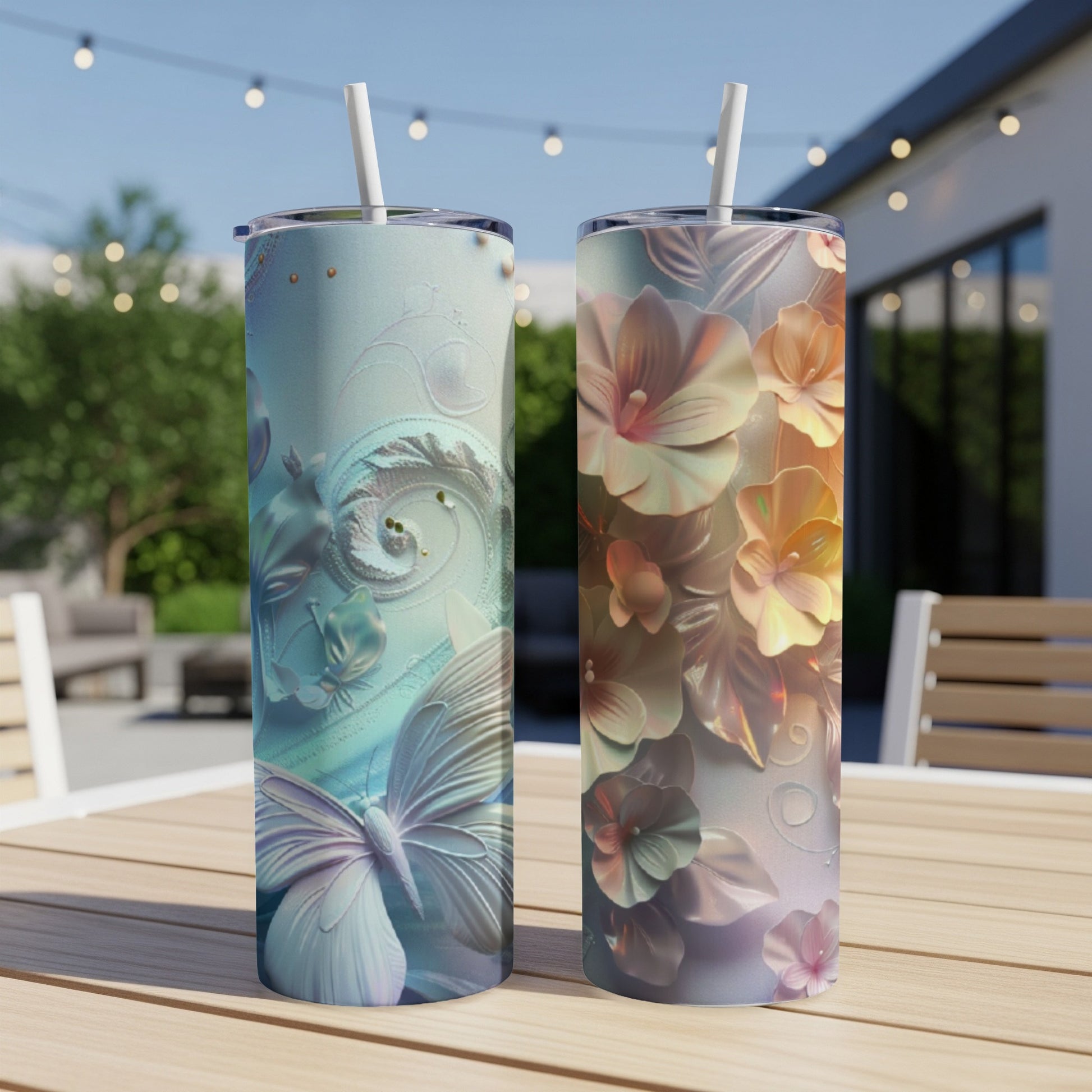 Two tumblers with floral and butterfly designs on a wooden table.