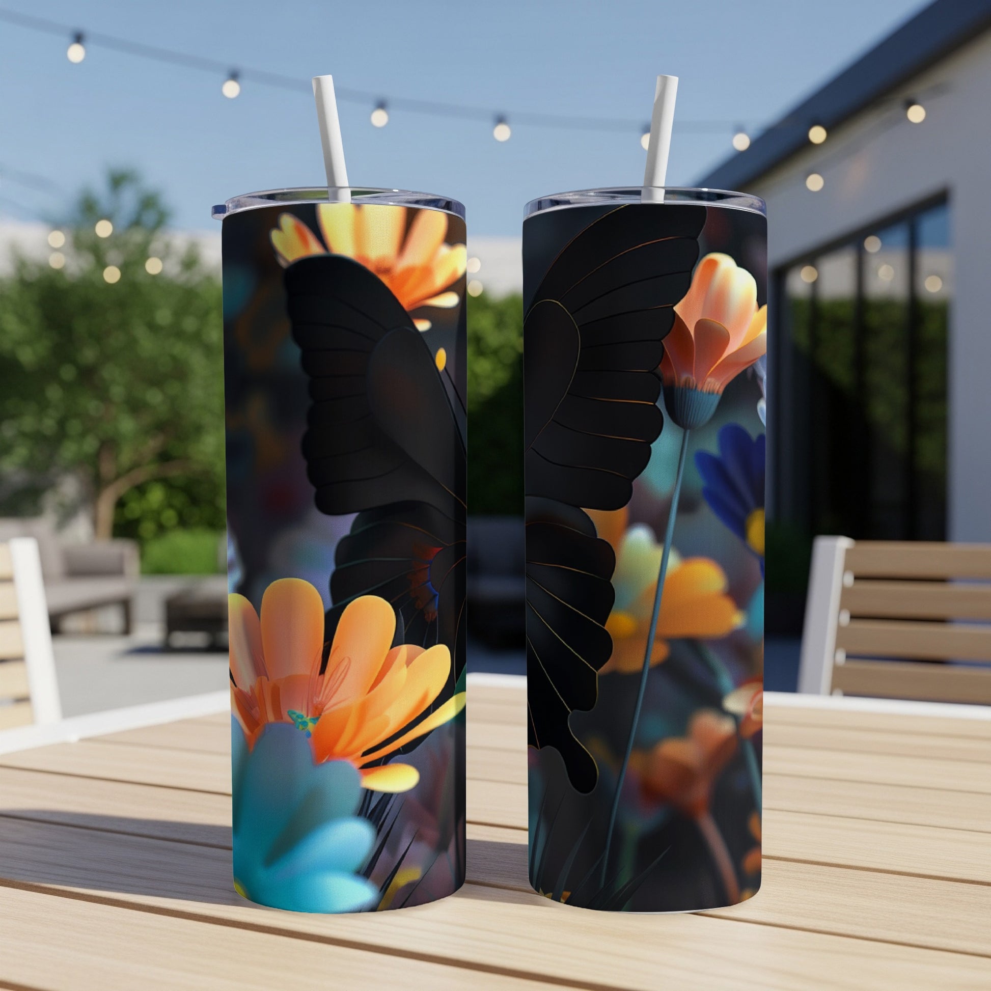 Two tumblers with a black butterfly and floral design on an outdoor table.