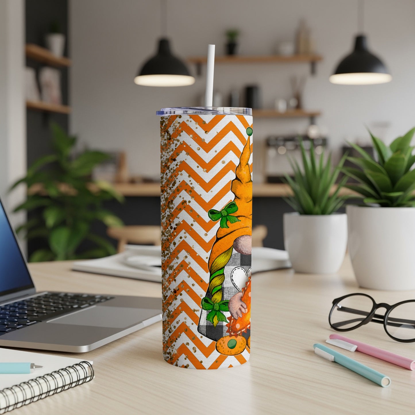 Gnome on a skinny tumbler with orange chevron and plaid pumpkin.
