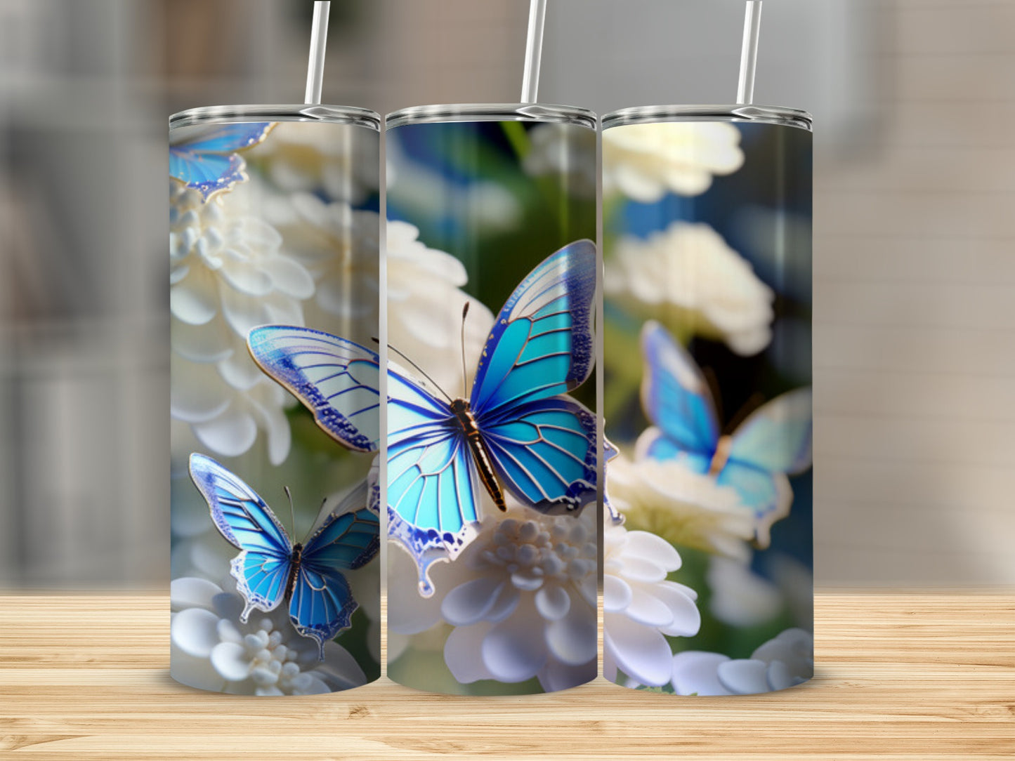 Three tumblers with blue butterflies and white flowers design.
