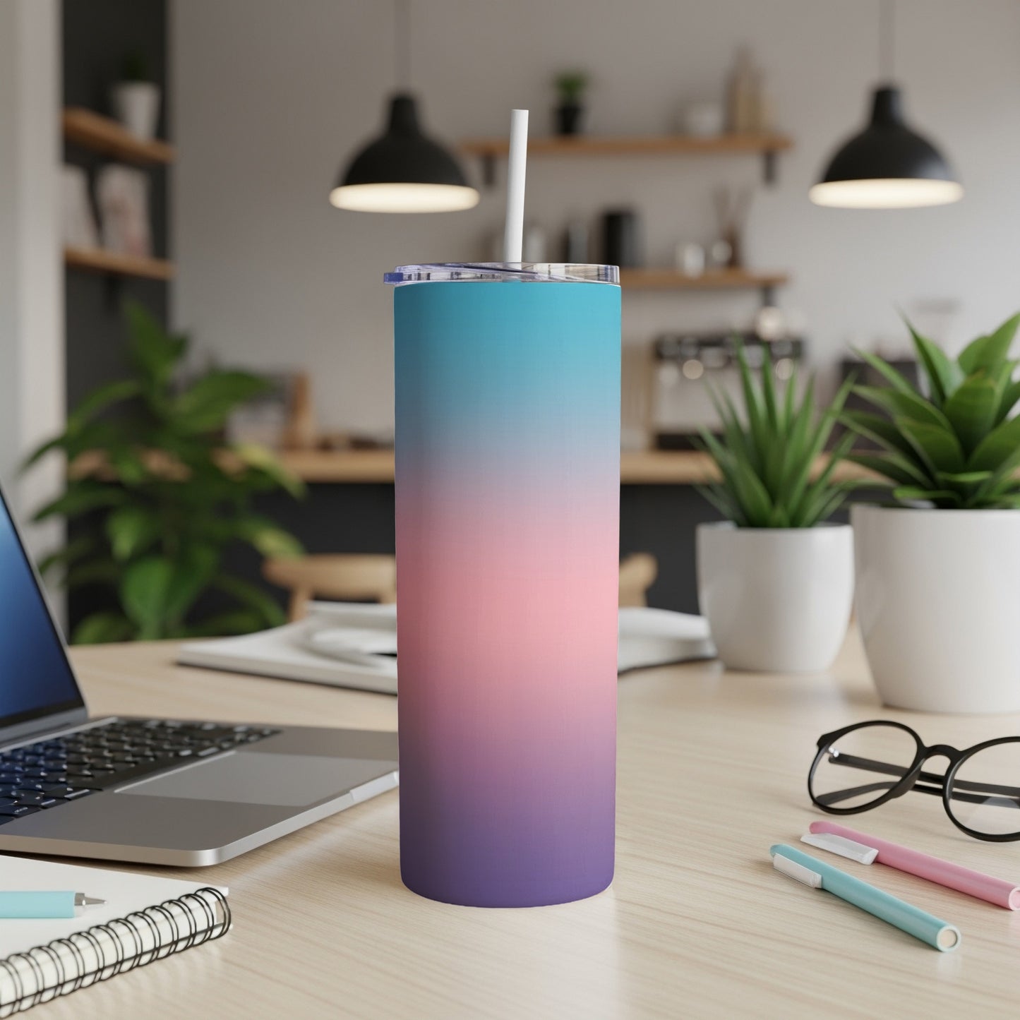 Gradient pink, purple, and blue insulated tumbler with a straw.