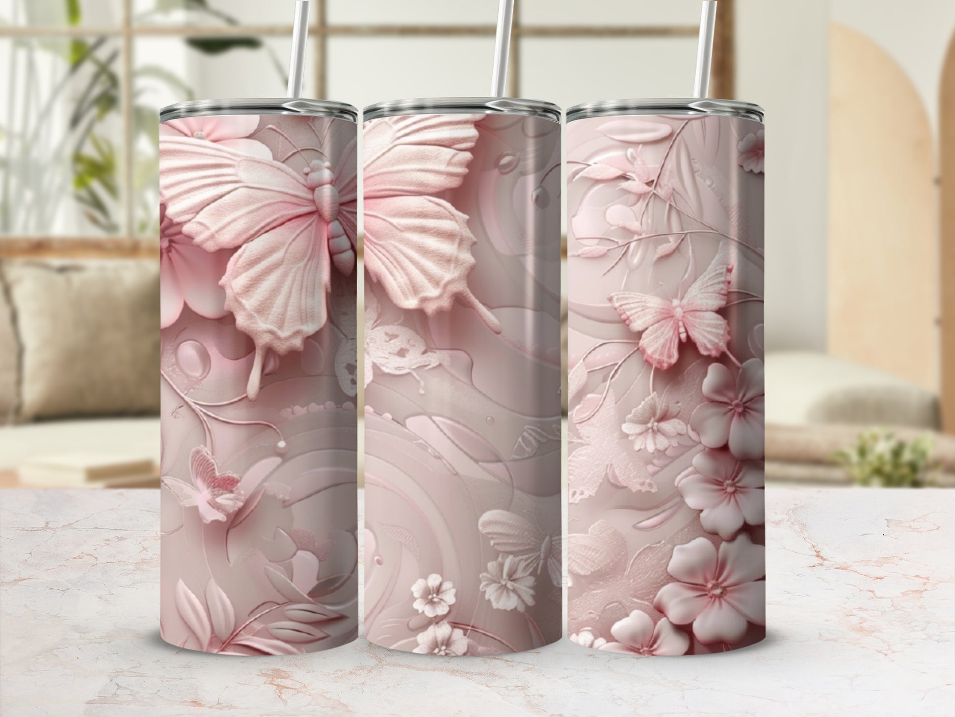 Pink floral and butterfly patterned tumbler with straw.