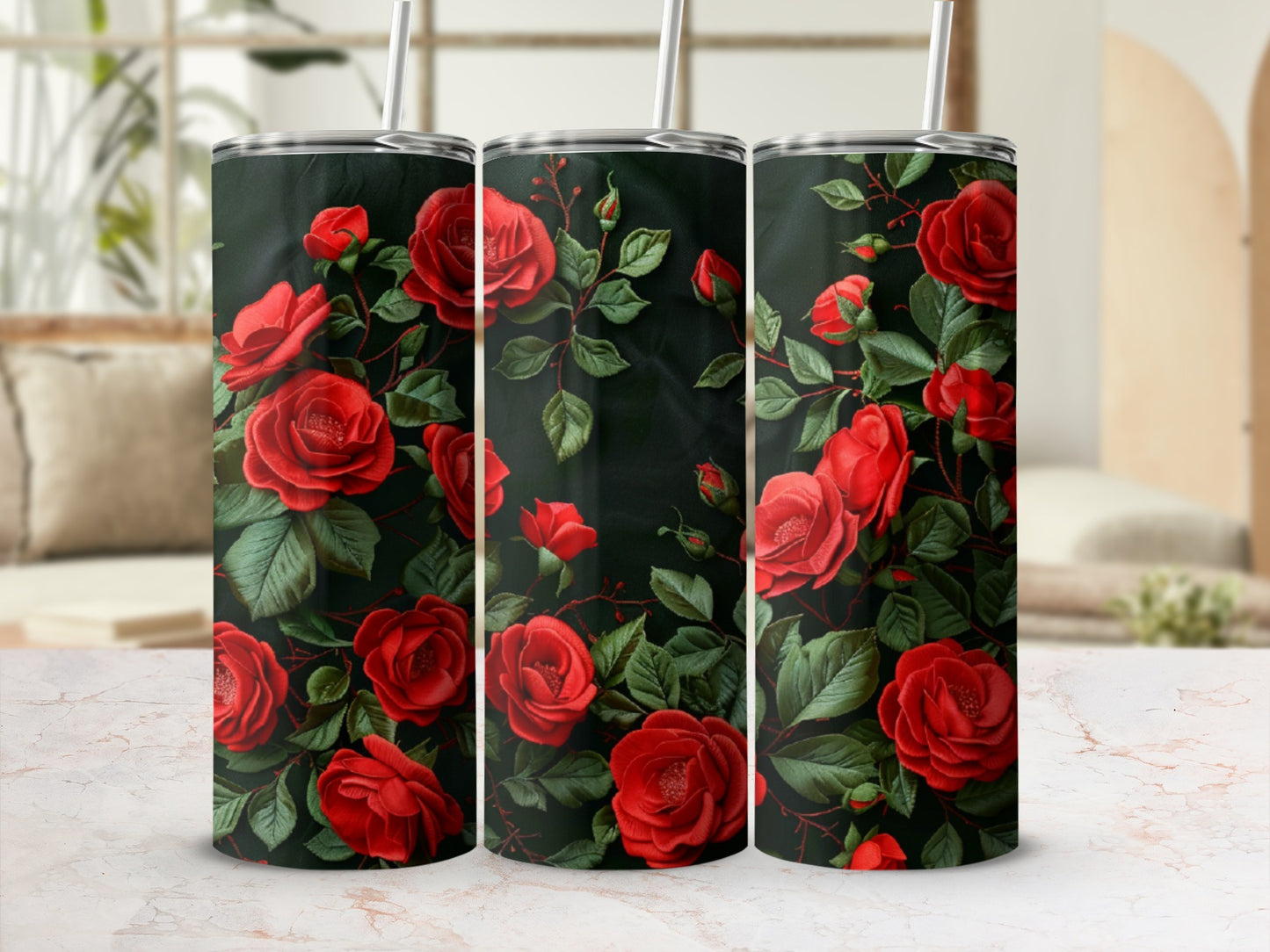 Three tumblers adorned with a pattern of deep red roses and green leaves.
