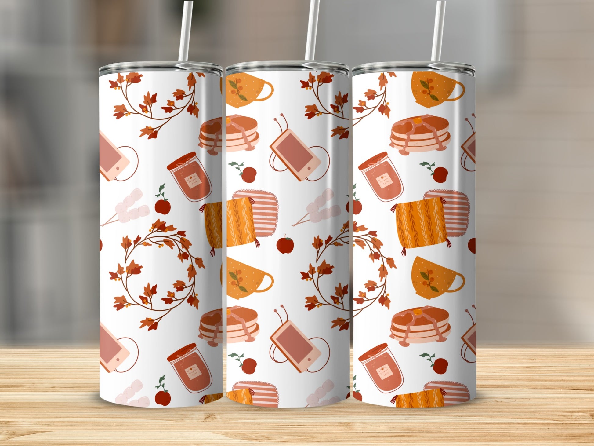 Three tumblers with fall-themed pattern of leaves, jam jars, and pancakes.