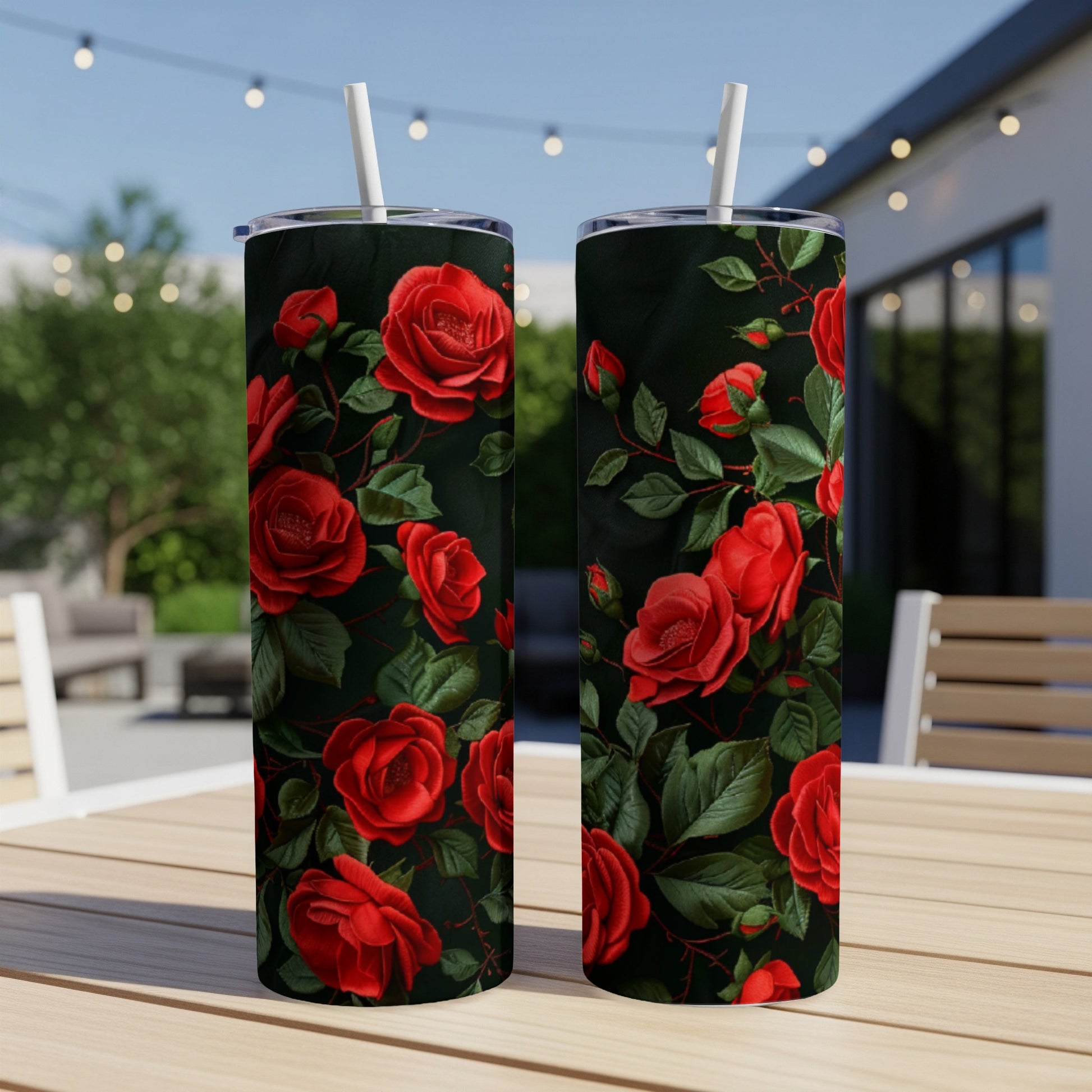 Two tumblers with a dark floral pattern of red roses and green leaves.