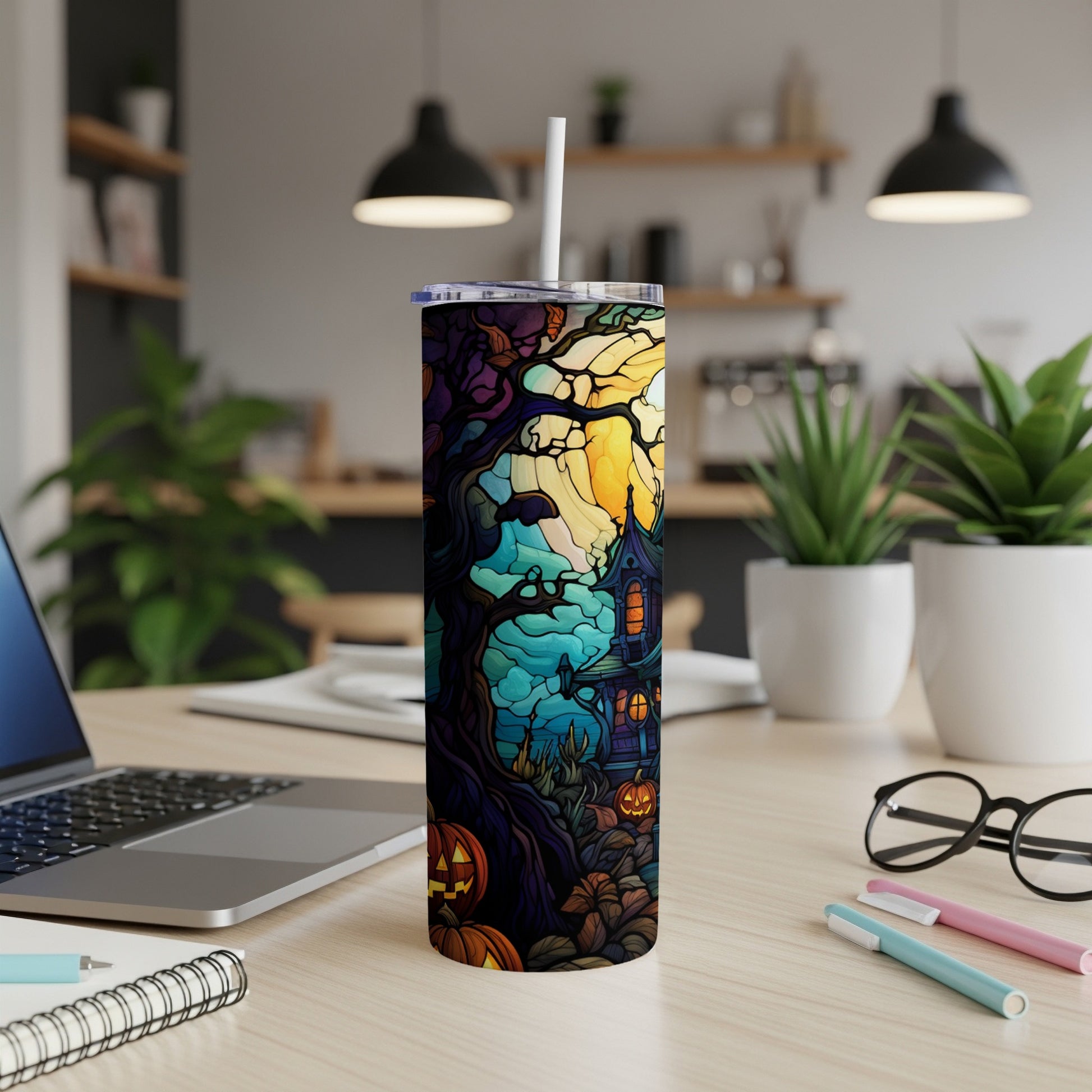 Halloween tumbler with spooky house, pumpkins, and bats against a colorful night sky.