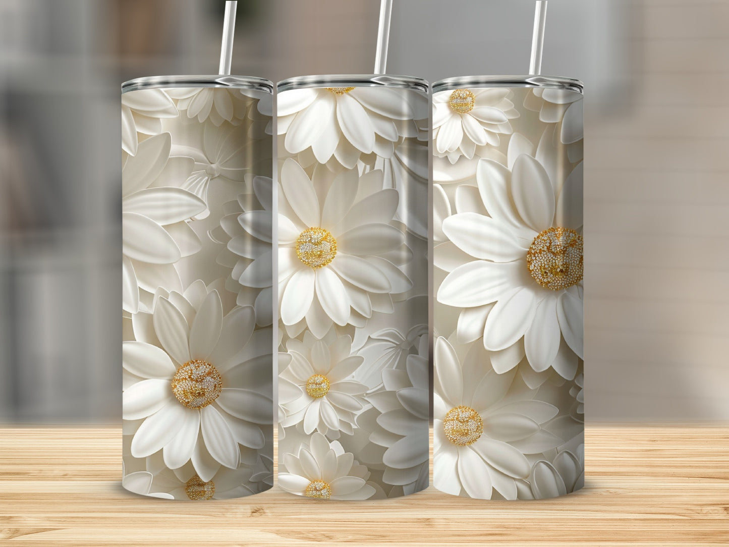 Three tumblers with a repeating pattern of white daisies with gold centers.