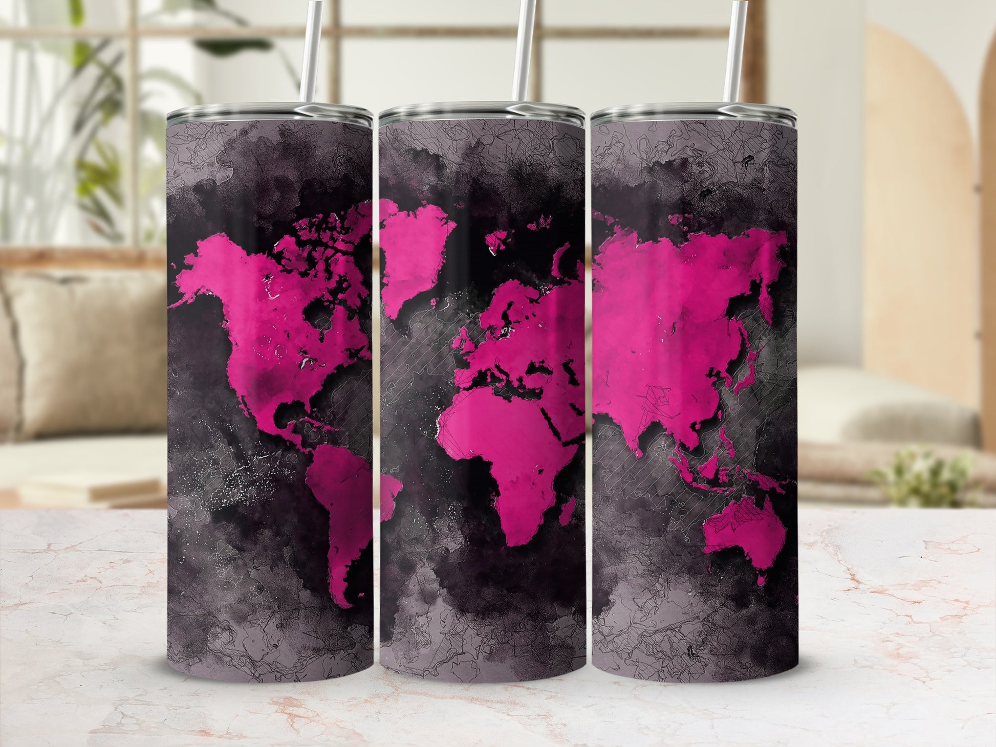 Three tumblers with a pink and black world map design and white straws.