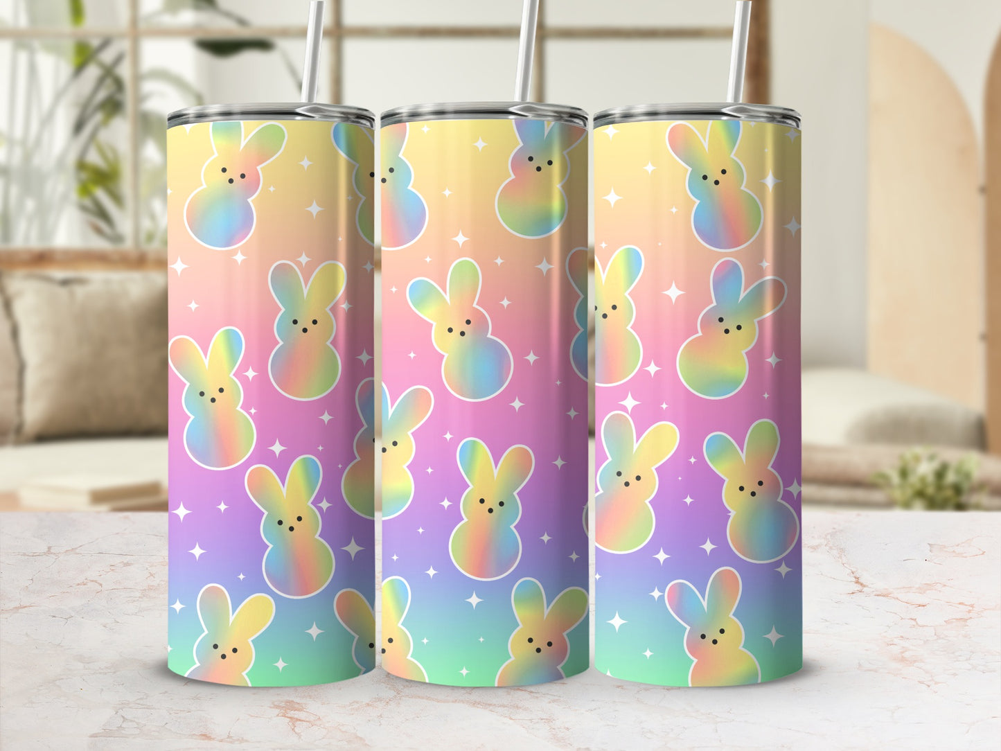 Pastel bunny pattern on three tall tumblers with straws.