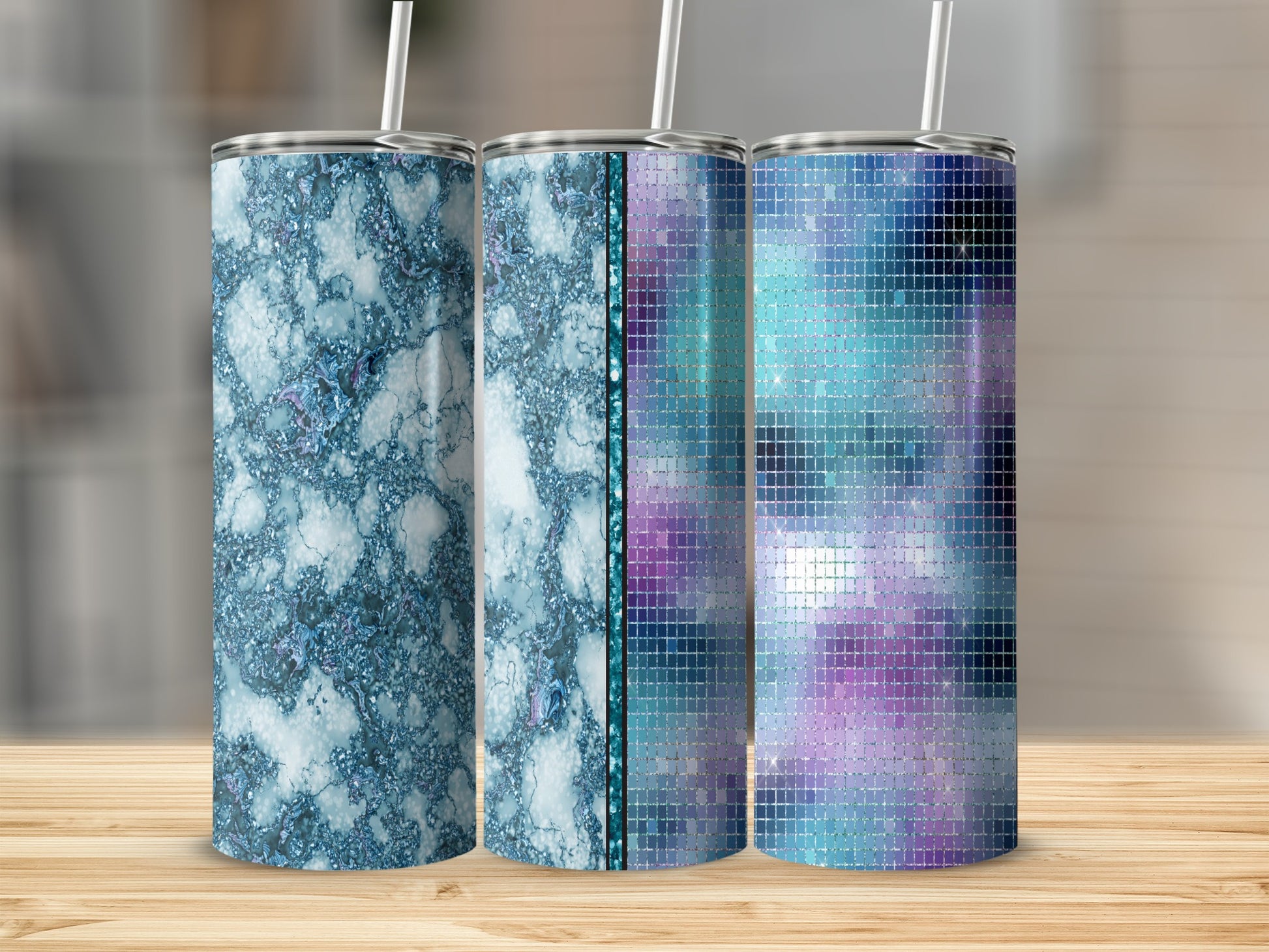 Three tumblers with marbled, textured, and mosaic patterns on a wooden surface.