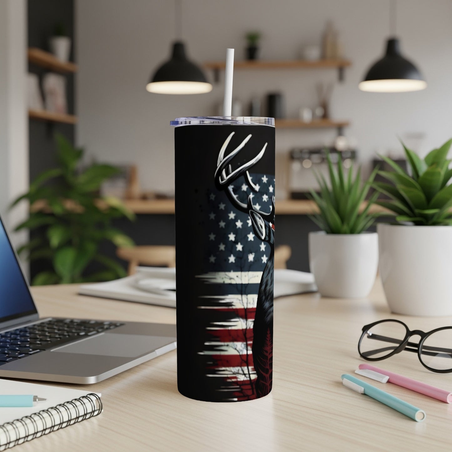 Tumbler with a deer silhouette and American flag design, with a white straw.