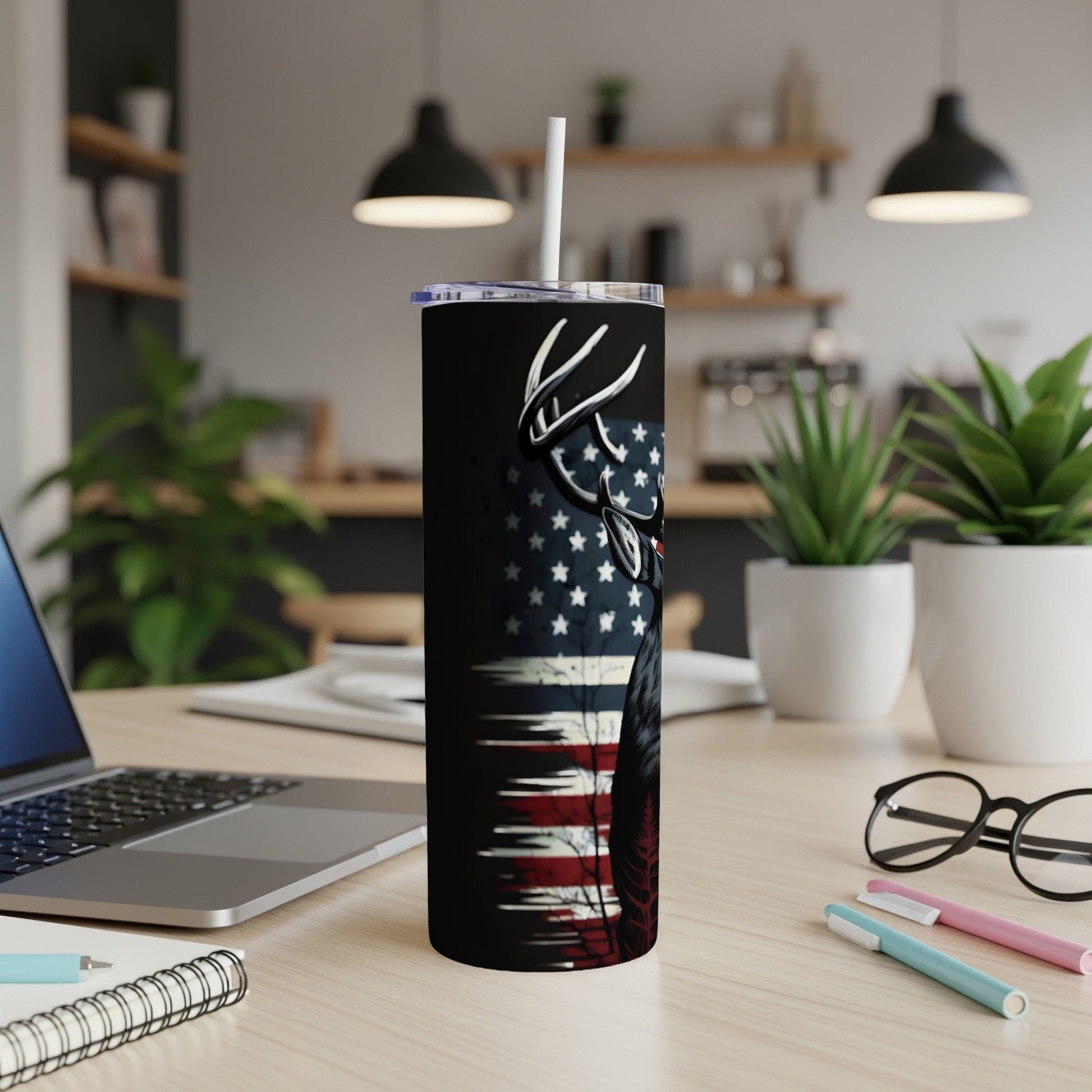 Tumbler with a deer silhouette and American flag design, with a white straw.