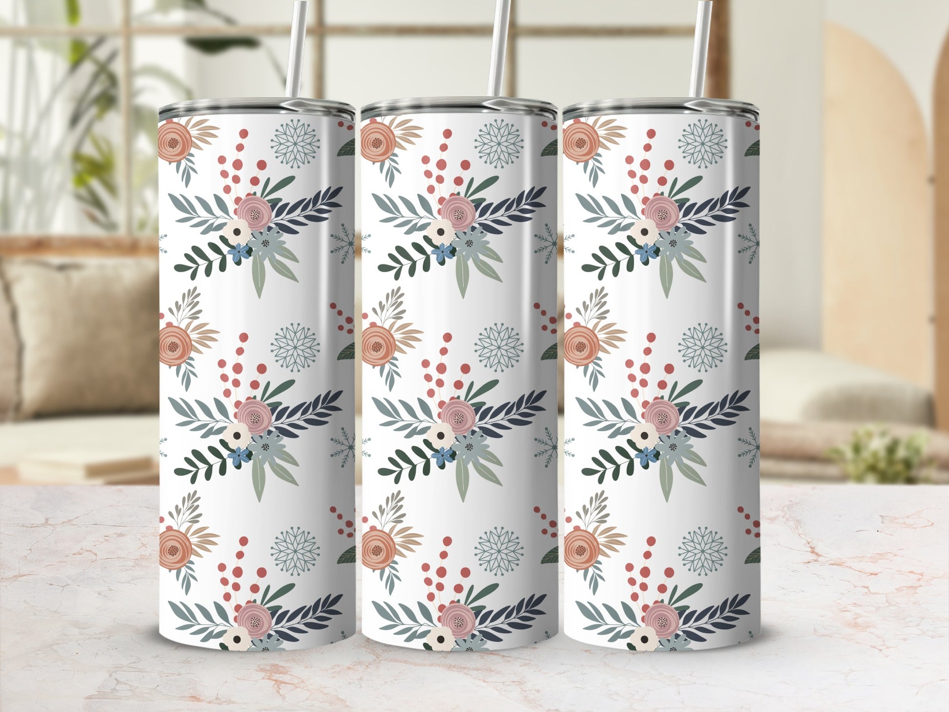 Three tumblers with a floral pattern on a marble surface.