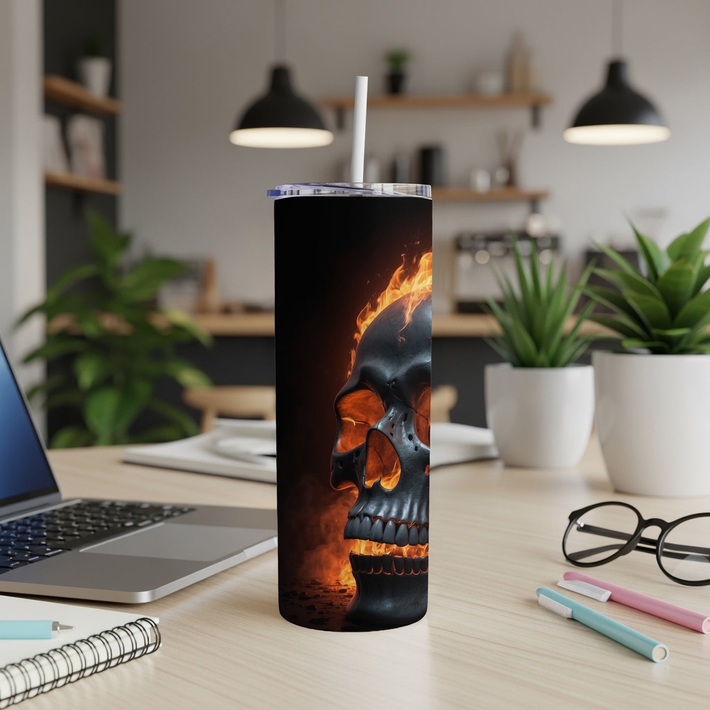 Black tumbler with a skull and flames design.