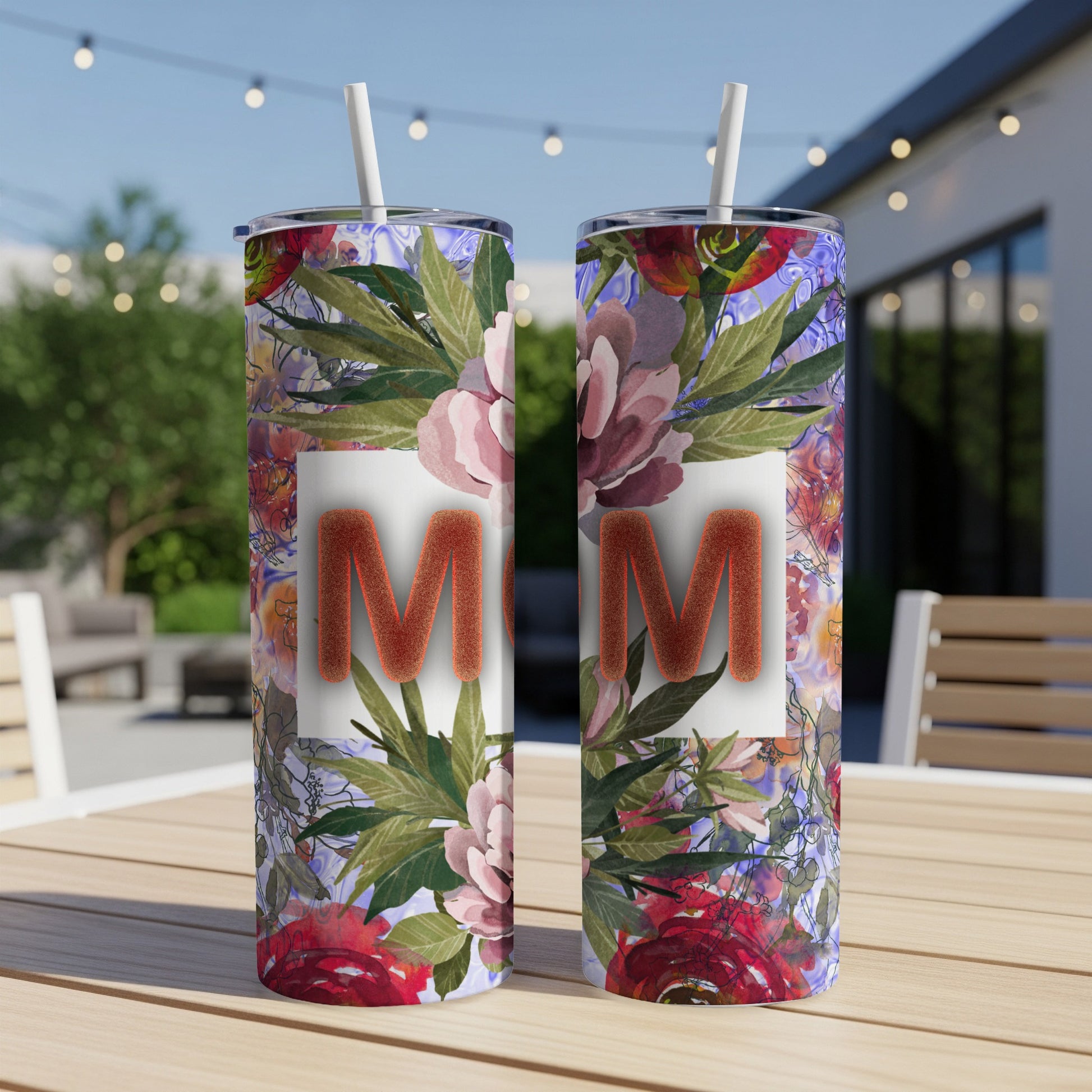 Two floral tumblers with "MOM" in orange text on a white background.