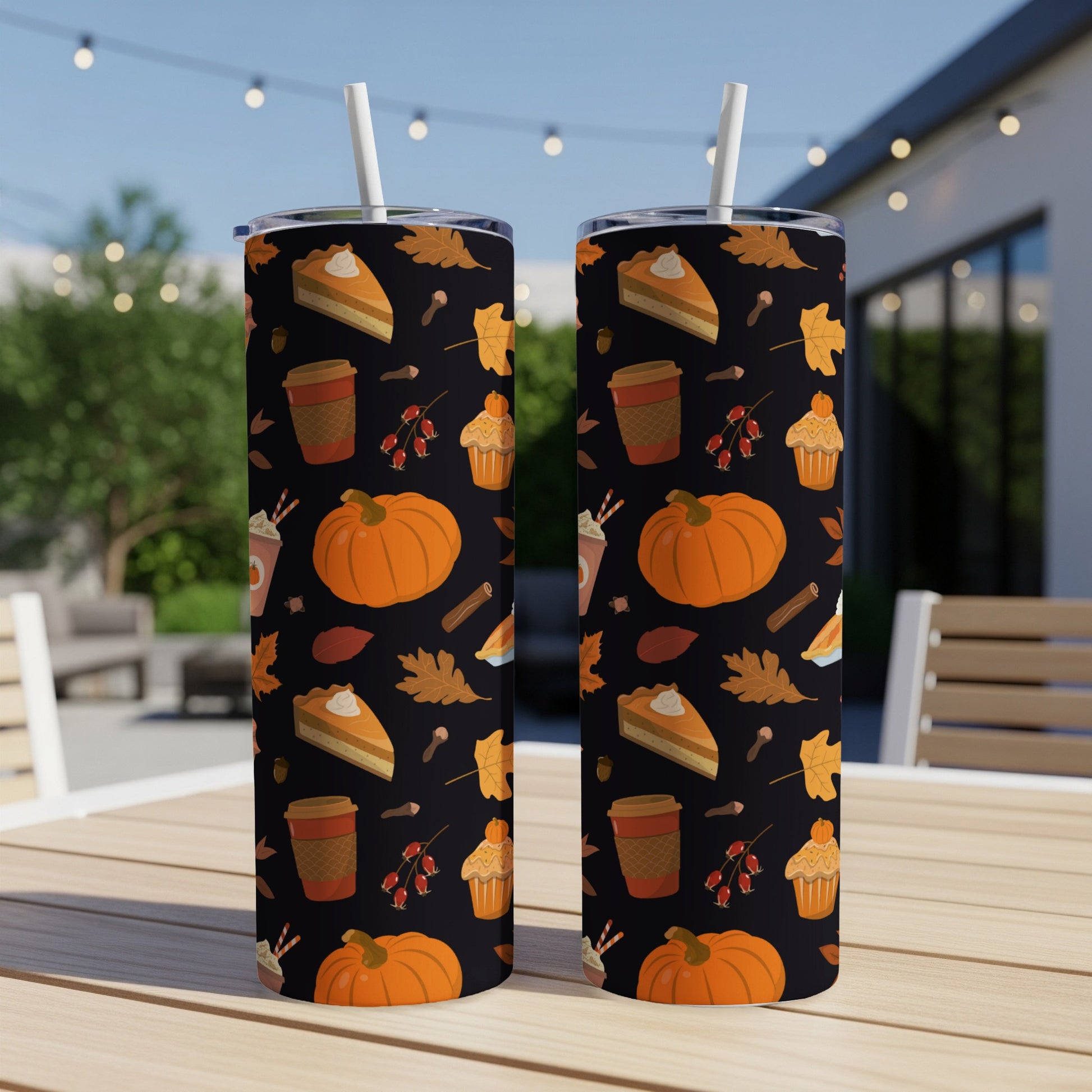 Two tumblers with fall-themed pattern of pumpkins, pie, and leaves.