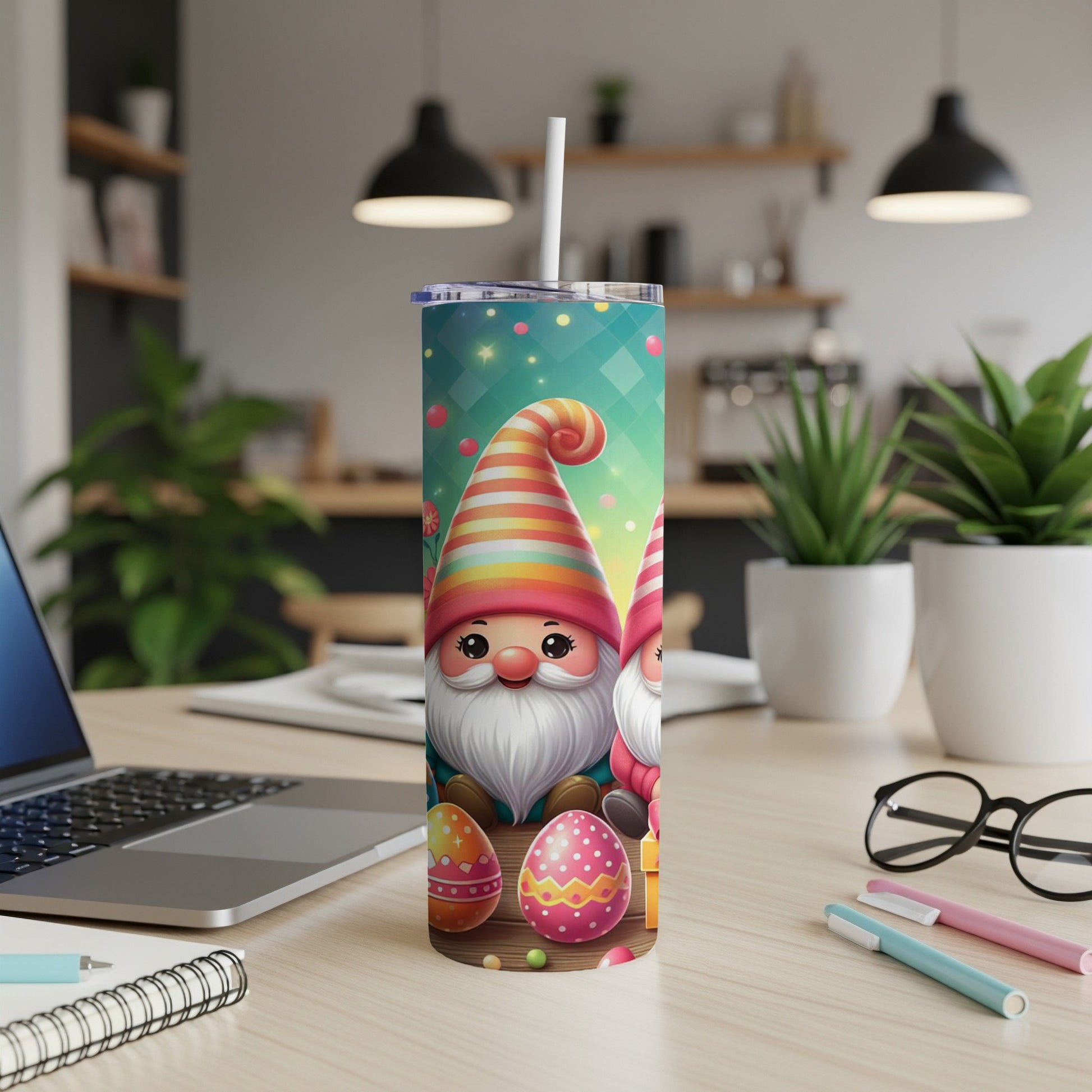 Two festive gnomes with striped hats stand by Easter eggs on a patterned tumbler.