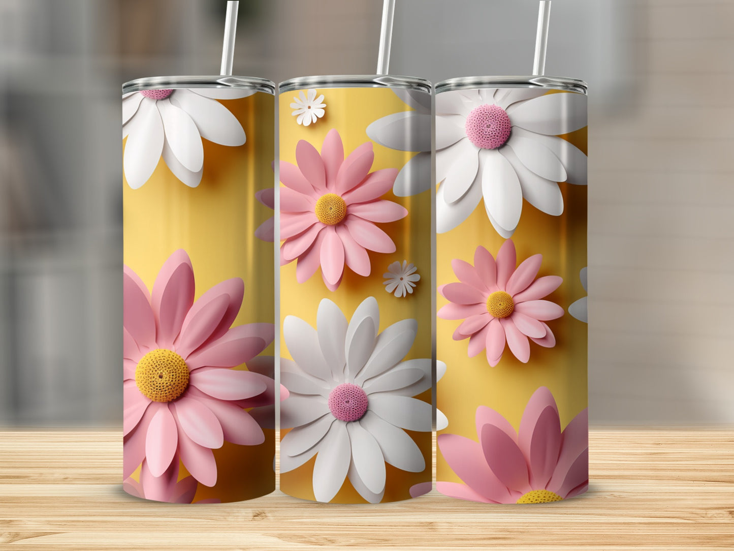 Three tumblers with pink and white daisies on a yellow background.