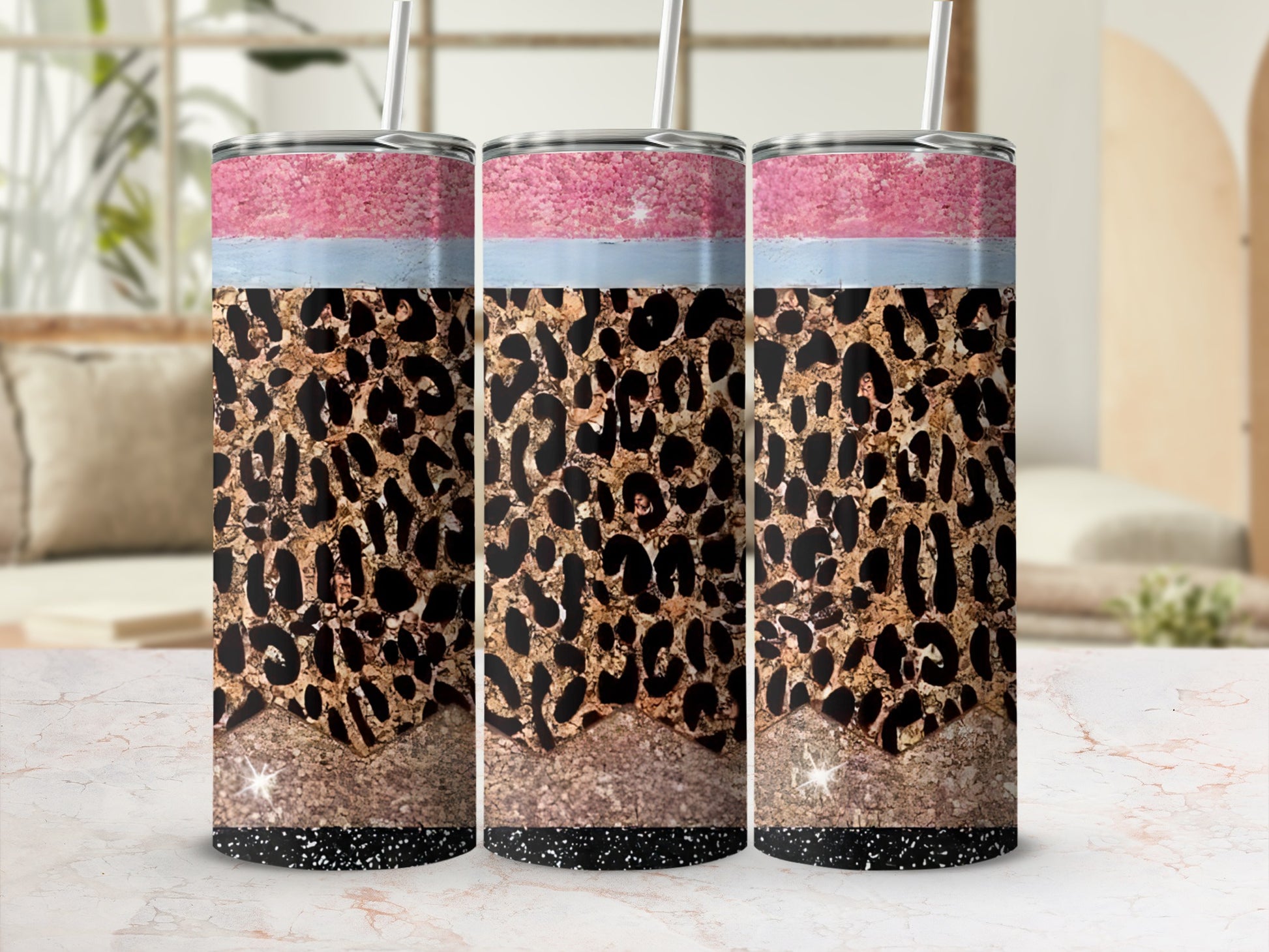 Leopard print tumbler with pink, blue, and gold glitter accents.
