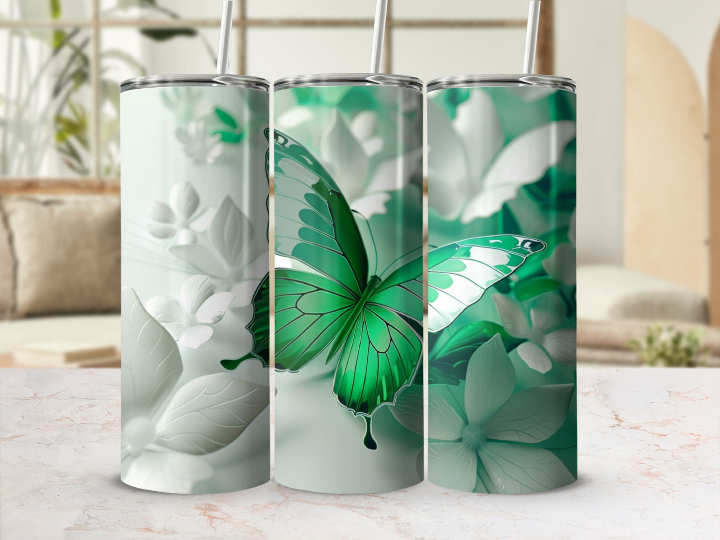 Green butterfly and flower design on three identical tumblers.
