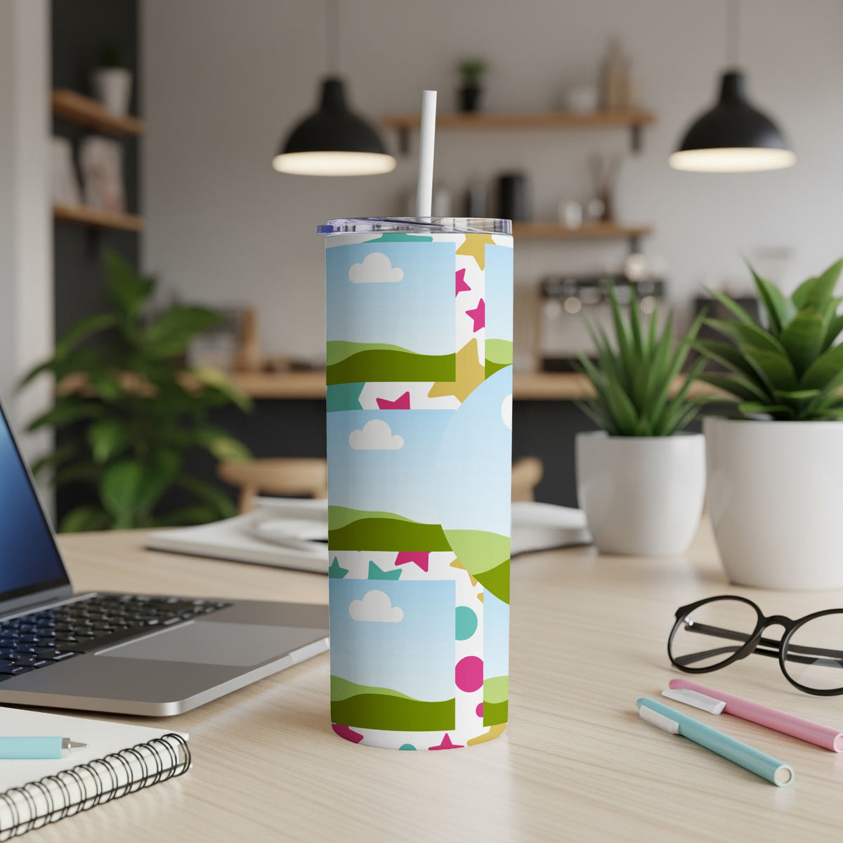 Tall tumbler with a whimsical design of clouds, hills, and colorful shapes.