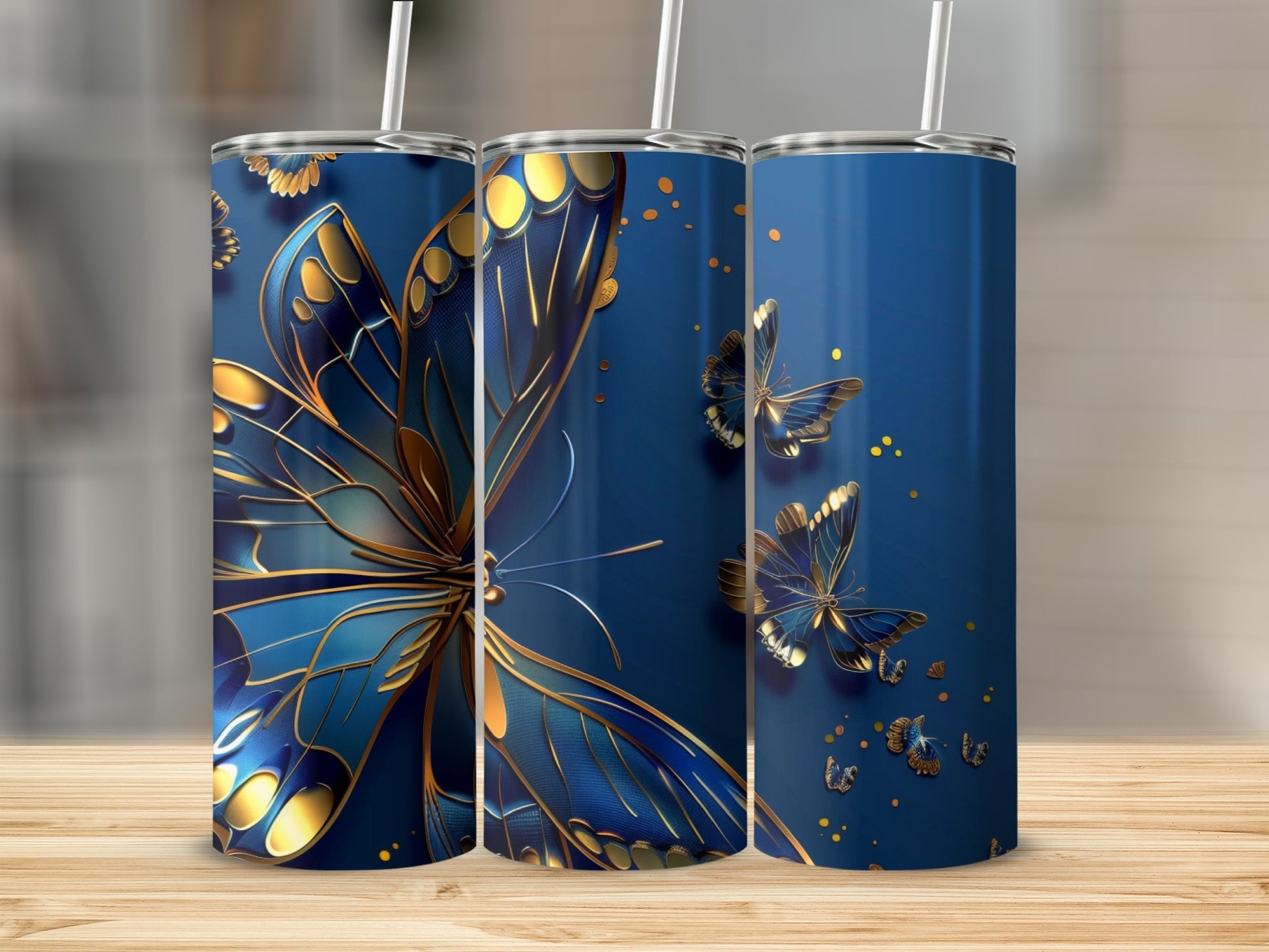 Three blue tumblers with golden butterflies and gold trim.