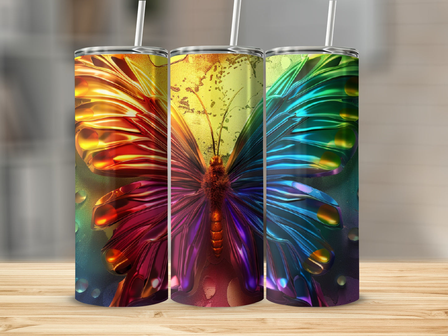 Three tumblers with iridescent butterfly wings and bokeh background.