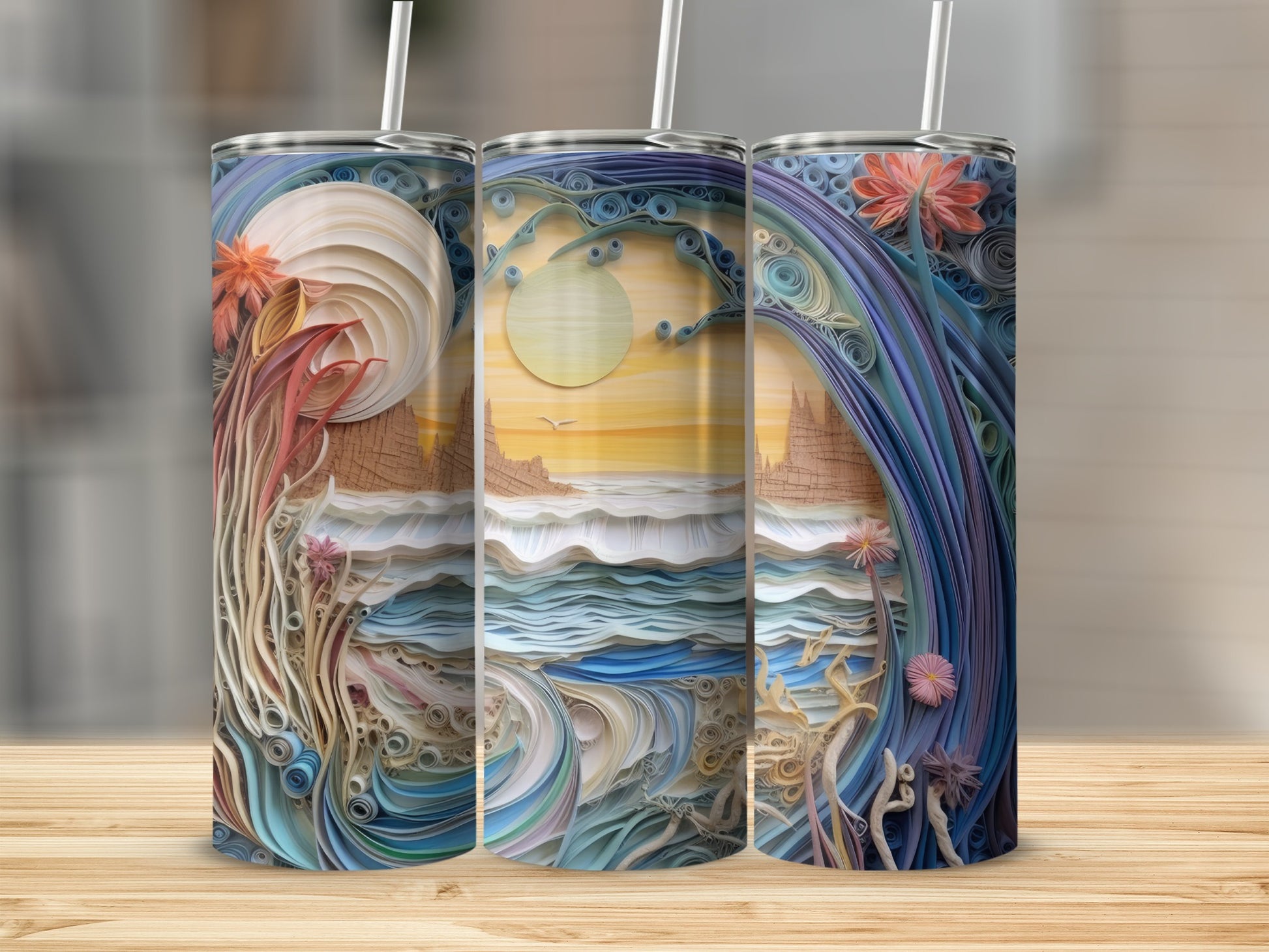 Three tumblers featuring a landscape artwork of waves, sun, and flowers.