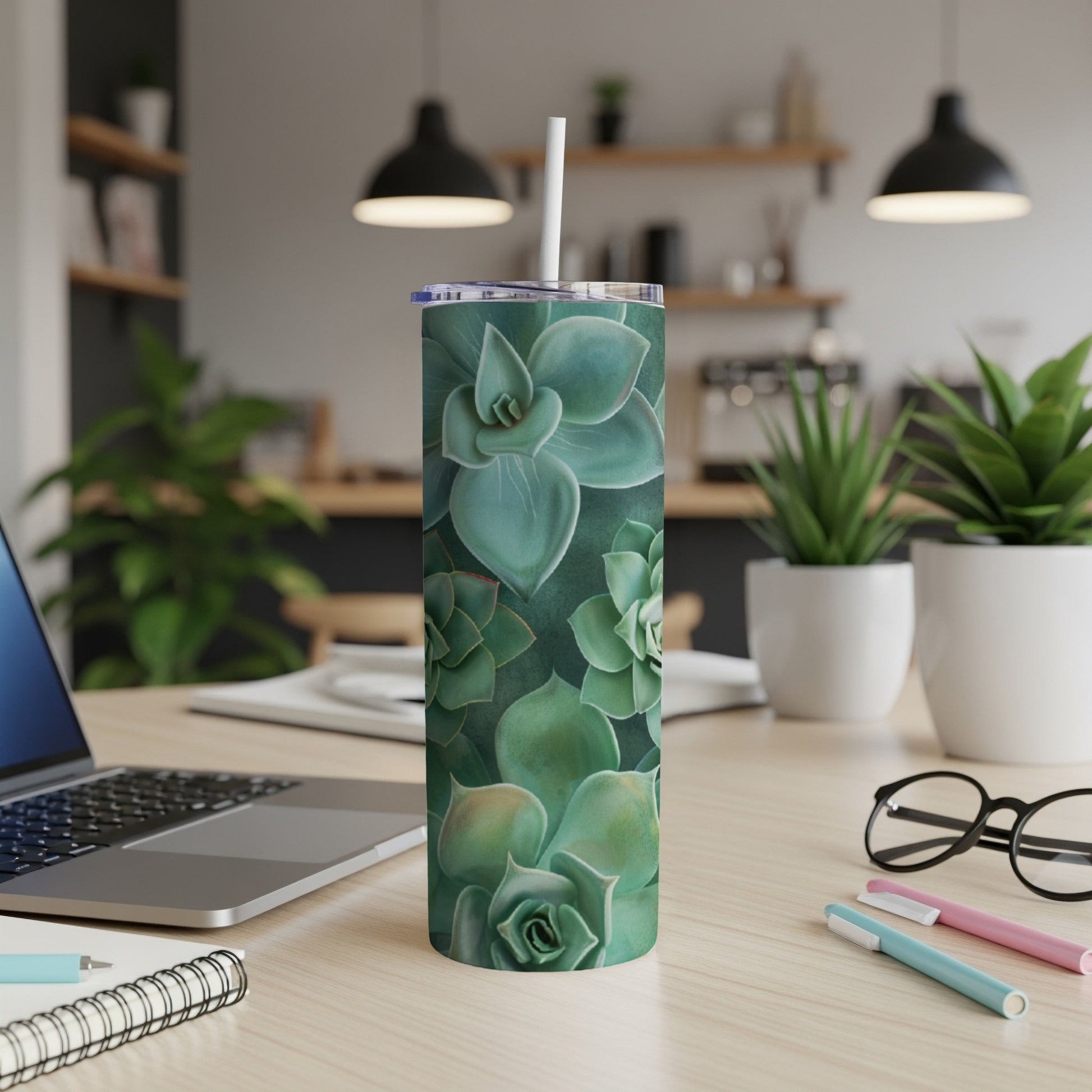 Green succulent pattern on a white insulated tumbler with a straw.