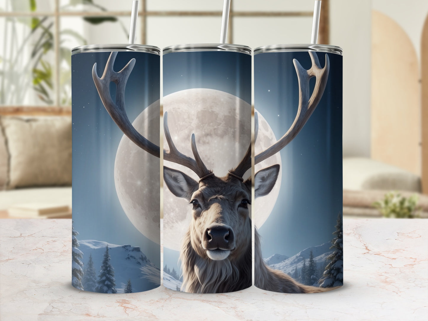 Deer and moon design on three travel tumblers in a rustic setting.
