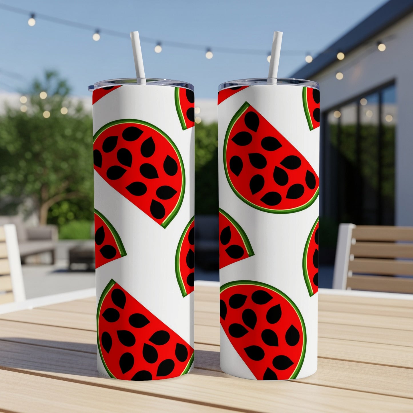 Two tumblers with a repeating watermelon slice pattern on a wooden table.