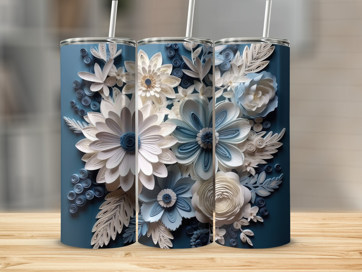 Three blue tumblers with white and blue paper flowers and leaves.