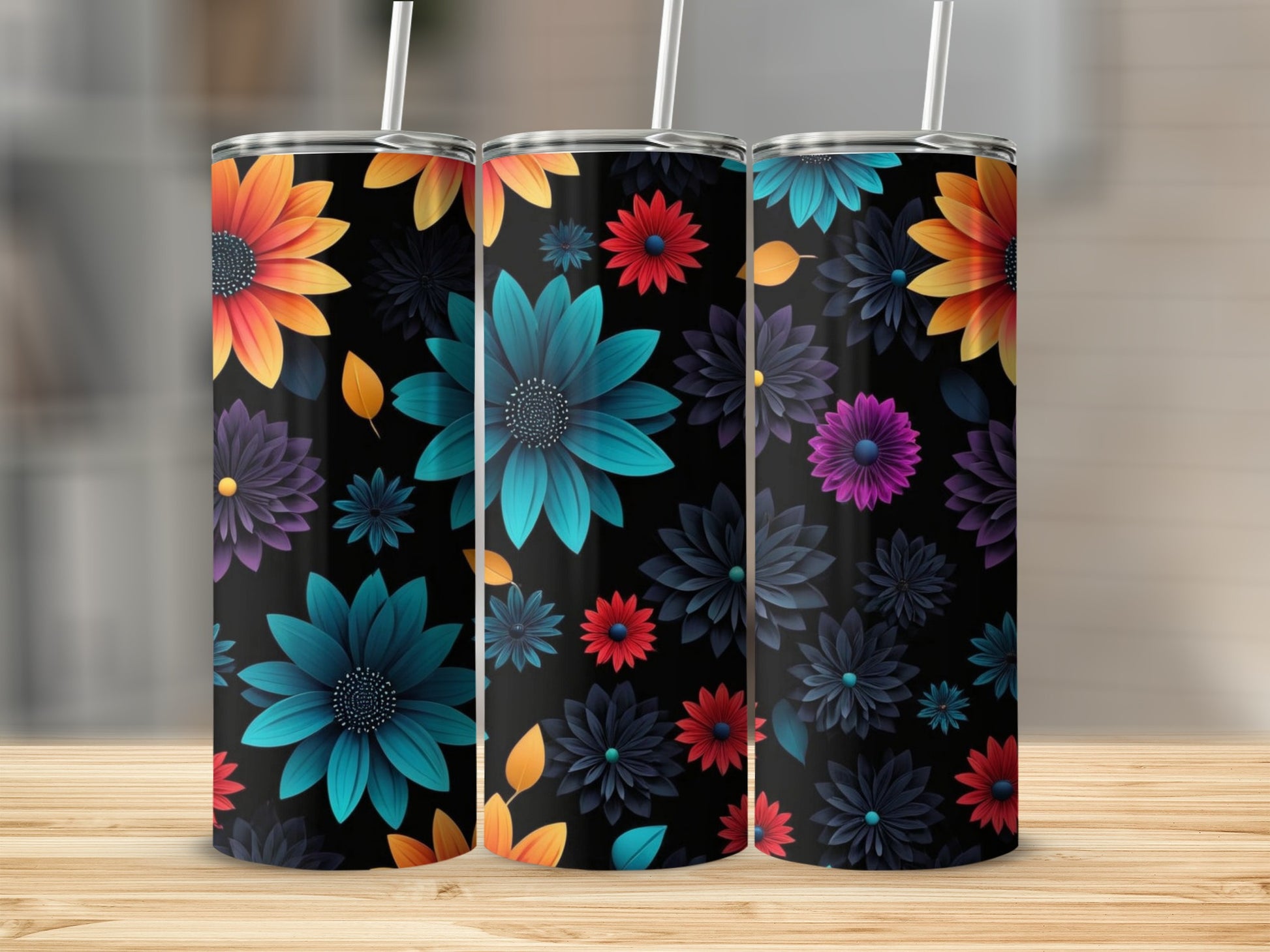 Three tumblers with floral patterns on a wooden surface.