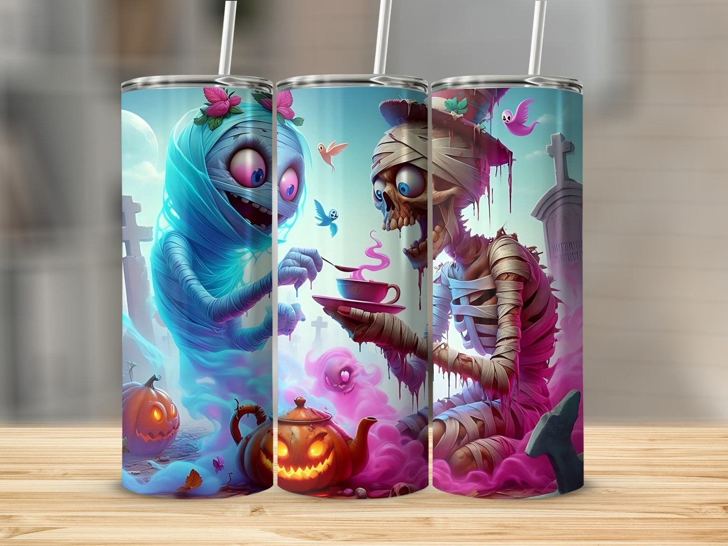Halloween mummy and skeleton tumblers with spooky graveyard and pumpkin designs.