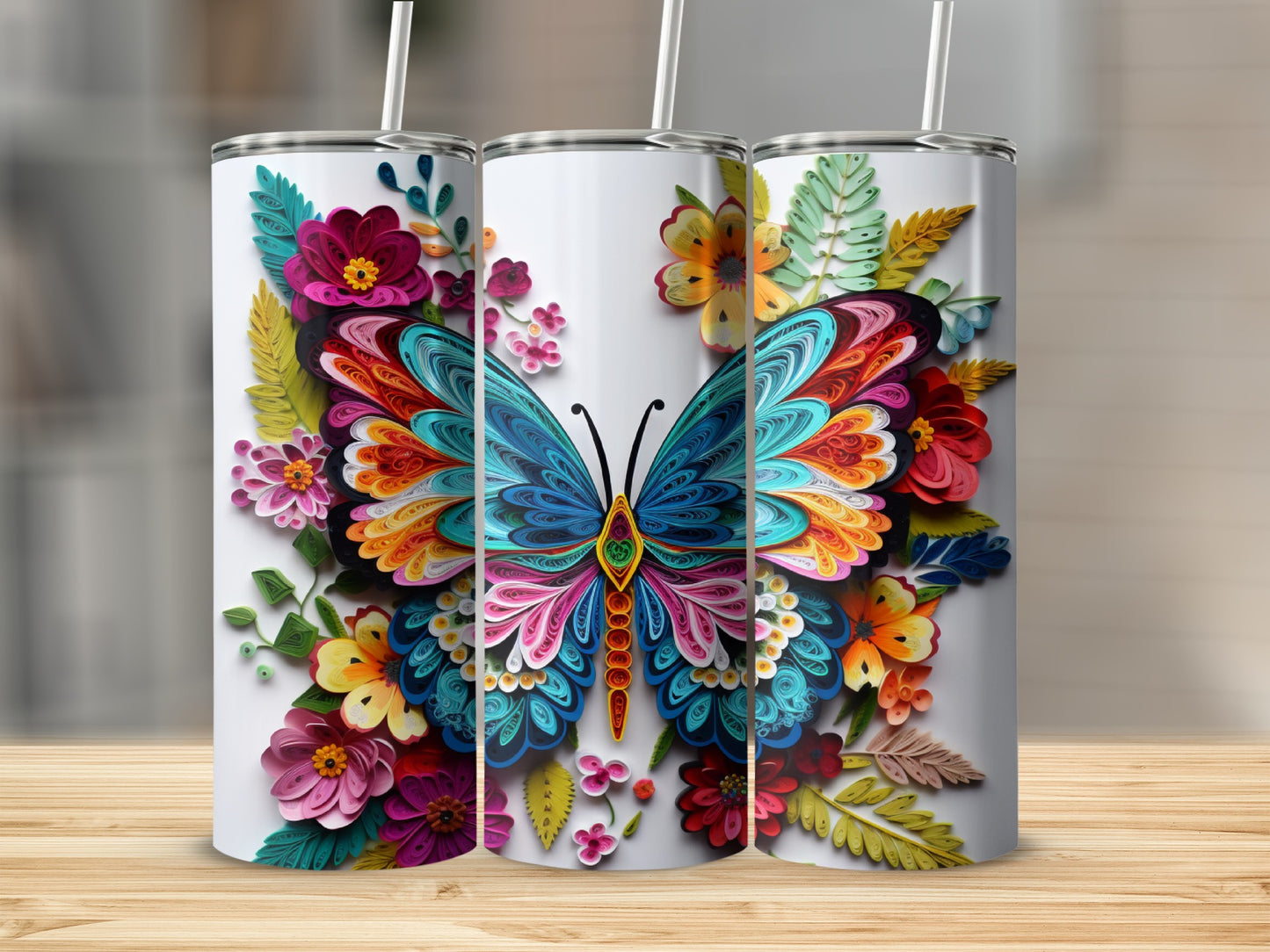 Three tumblers adorned with a vibrant, colorful butterfly and floral designs.