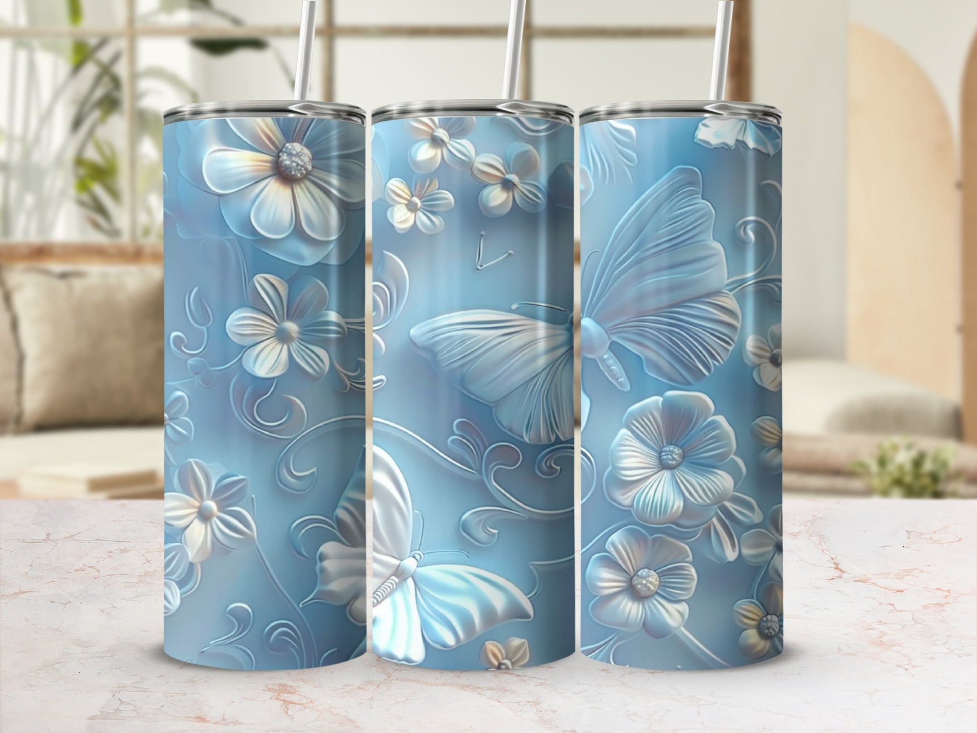 Three tumblers with blue floral and butterfly embossed design.
