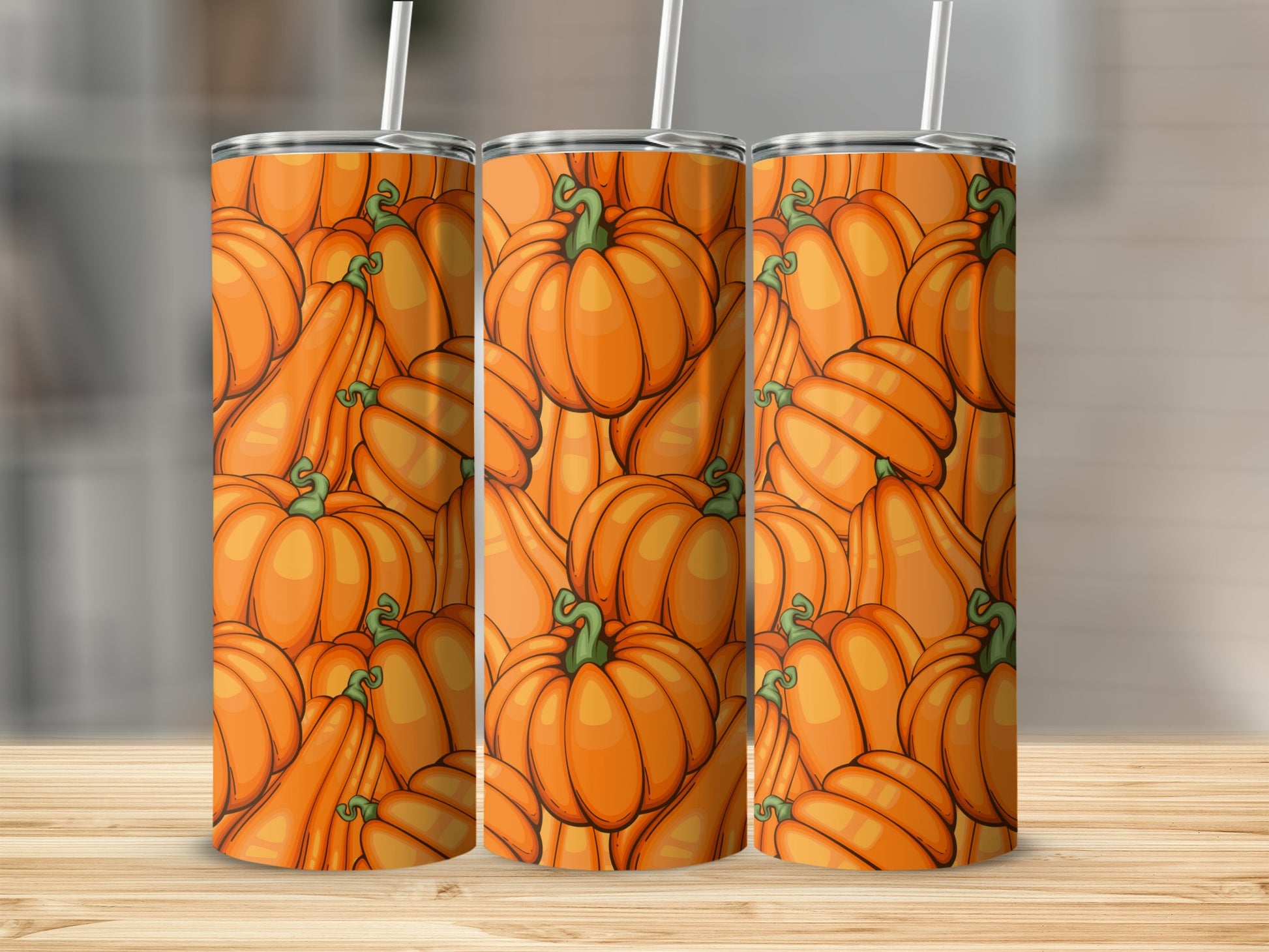 Three tumblers with an all-over pattern of cartoonish orange pumpkins.