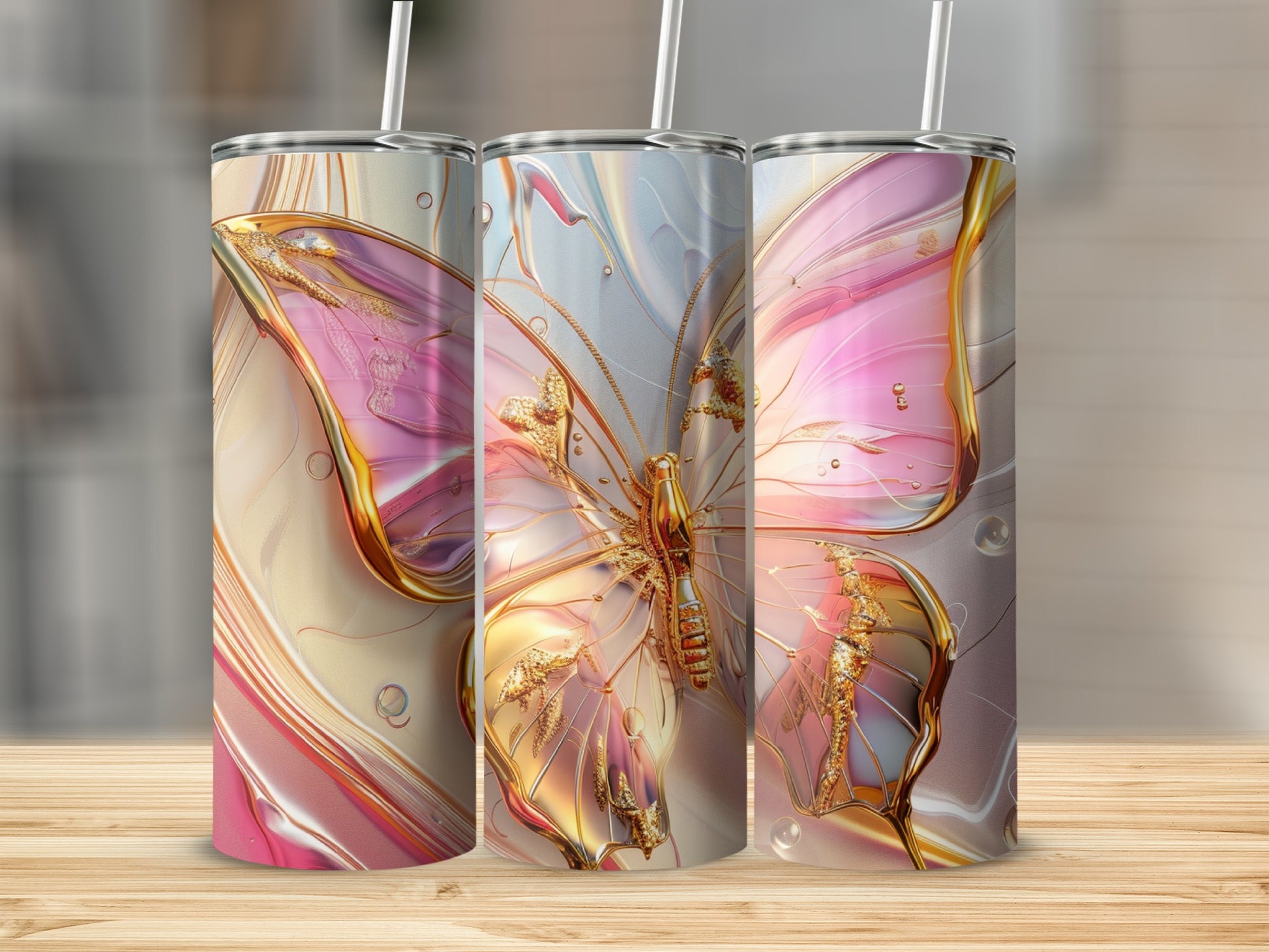 Three tumblers with iridescent pink and gold butterfly designs.