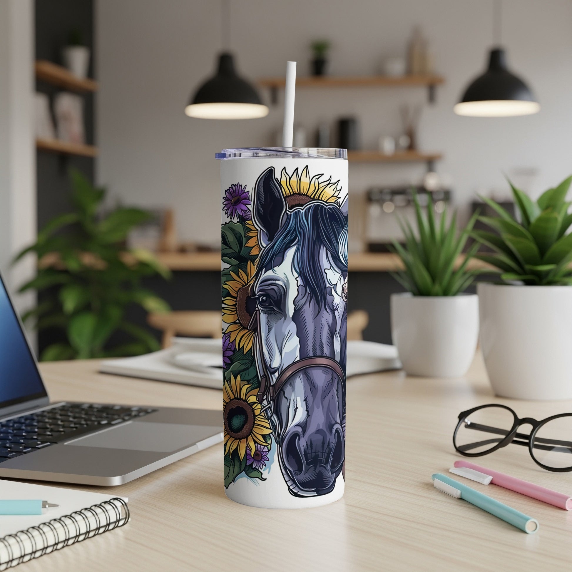 White tumbler with horse and sunflower design on a wooden desk.
